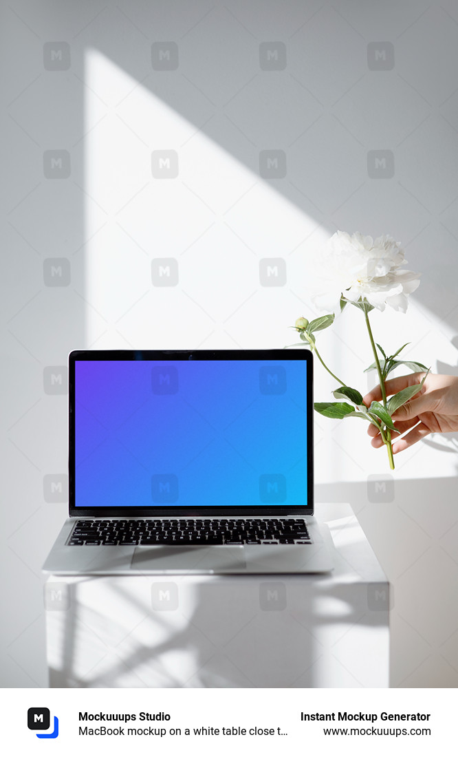 MacBook mockup on a white table close to the window