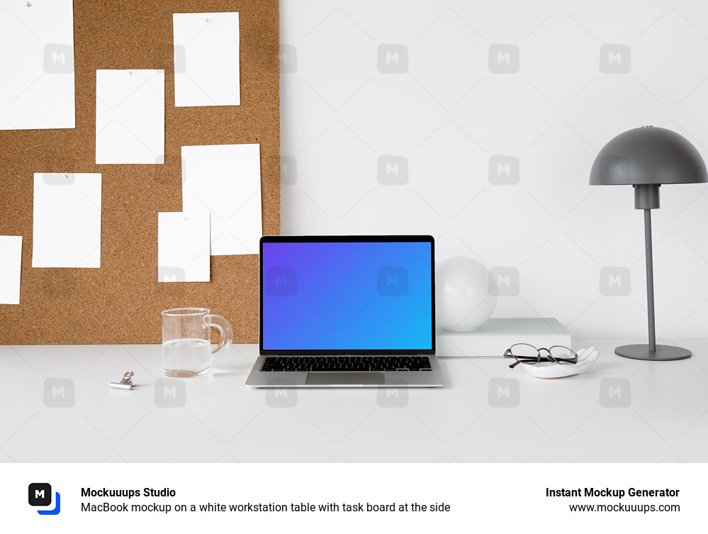 MacBook mockup on a white workstation table with task board at the side