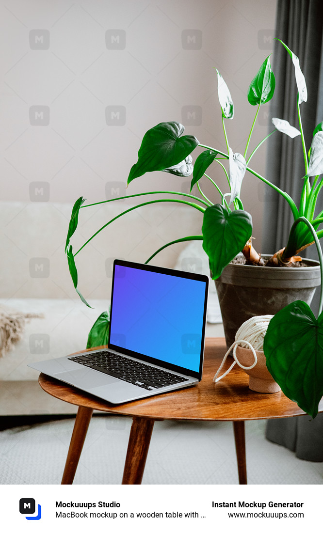MacBook mockup on a wooden table with flower pot
