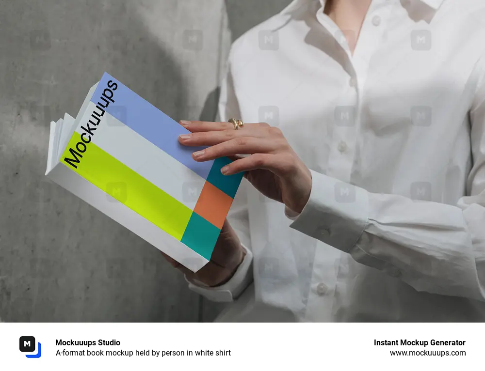 A-format book mockup held by person in white shirt