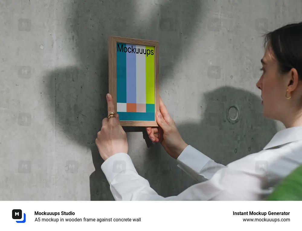 A5 mockup in wooden frame against concrete wall