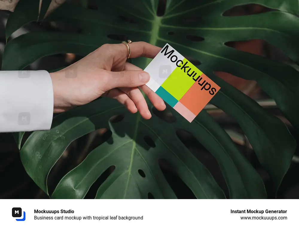 Business card mockup with tropical leaf background