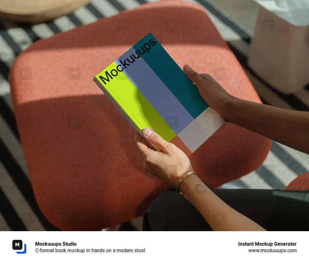 C-format book mockup in hands on a modern stool