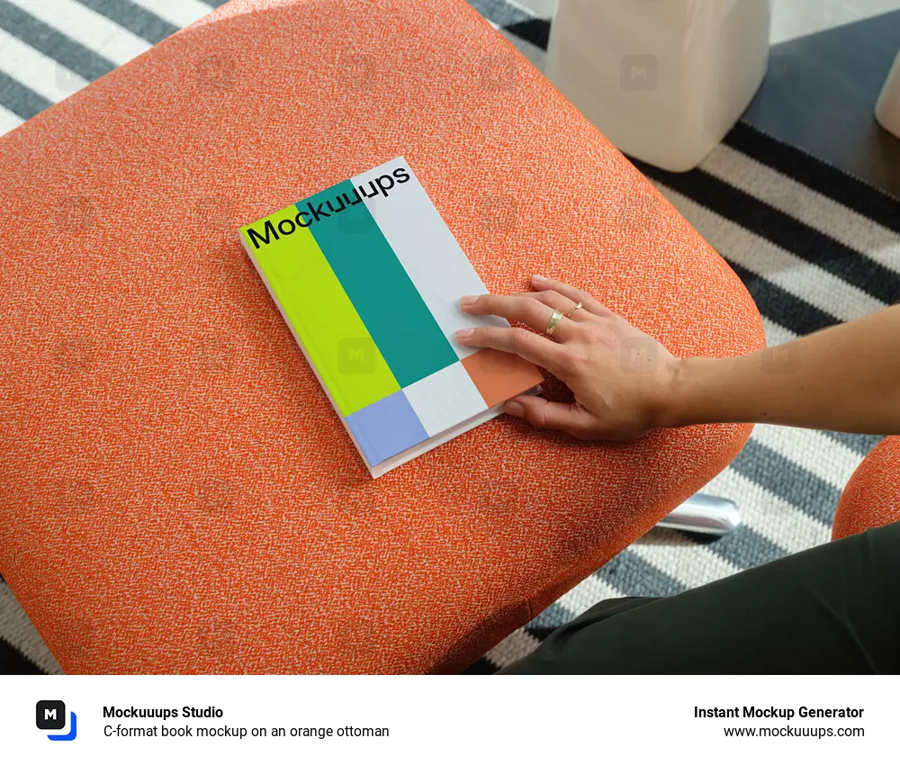 C-format book mockup on an orange ottoman