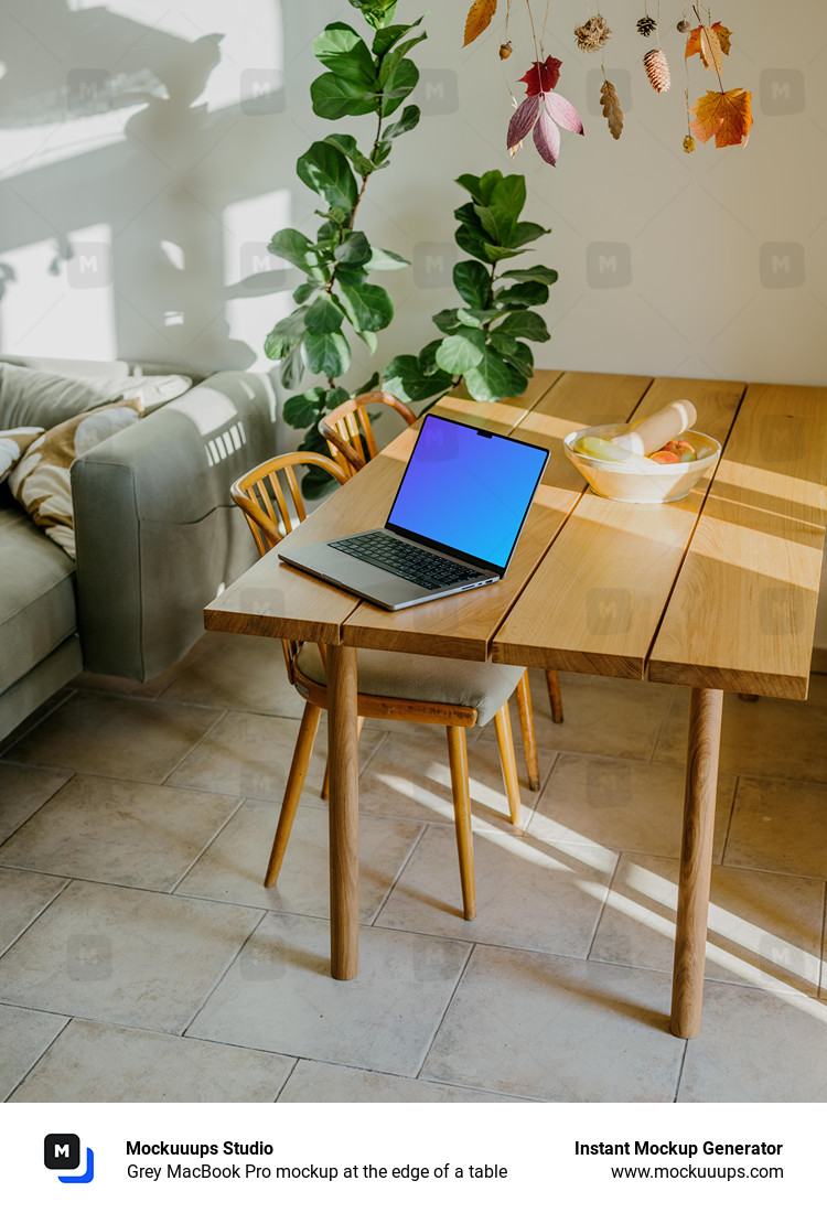 Grey MacBook Pro mockup at the edge of a table