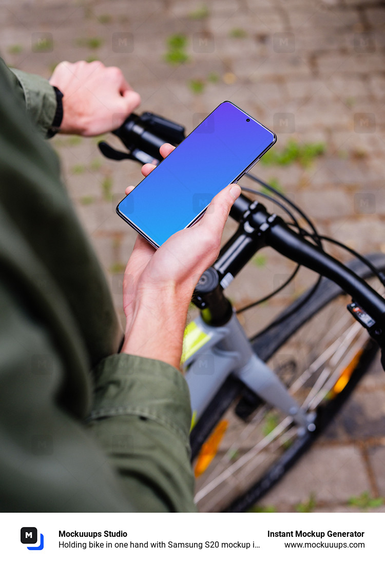 Holding bike in one hand with Samsung S20 mockup in the other