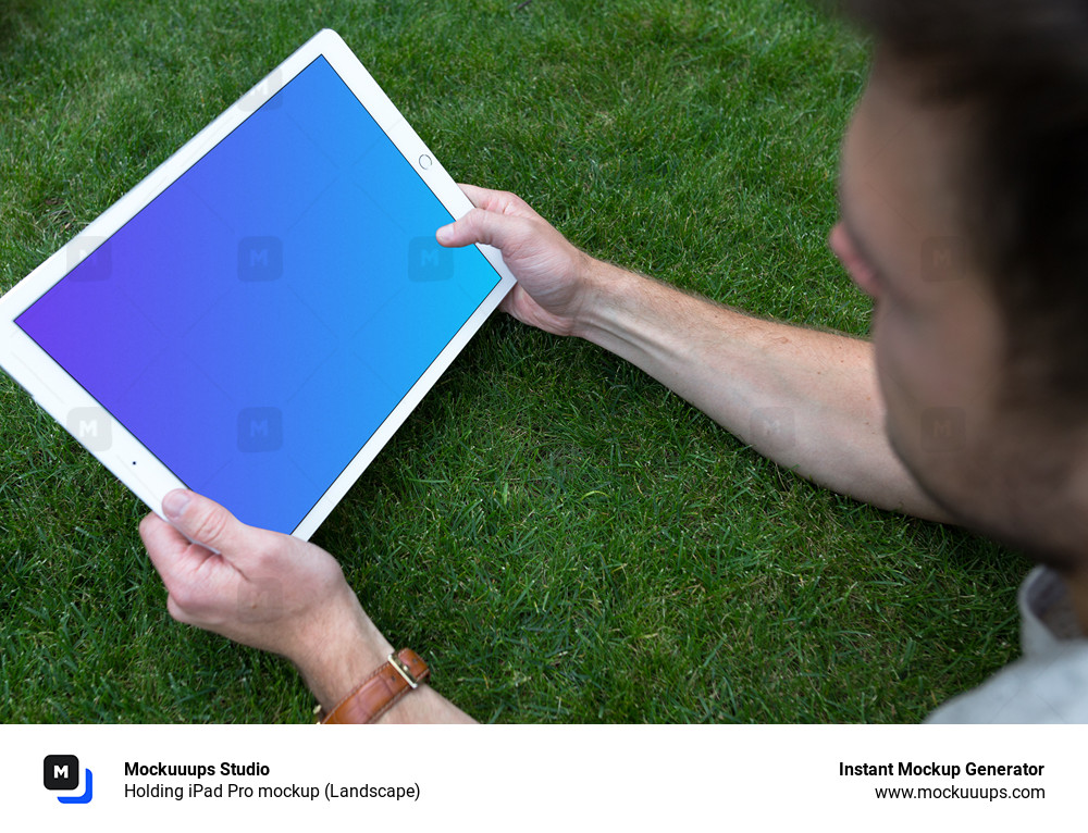 Holding iPad Pro mockup (Landscape)