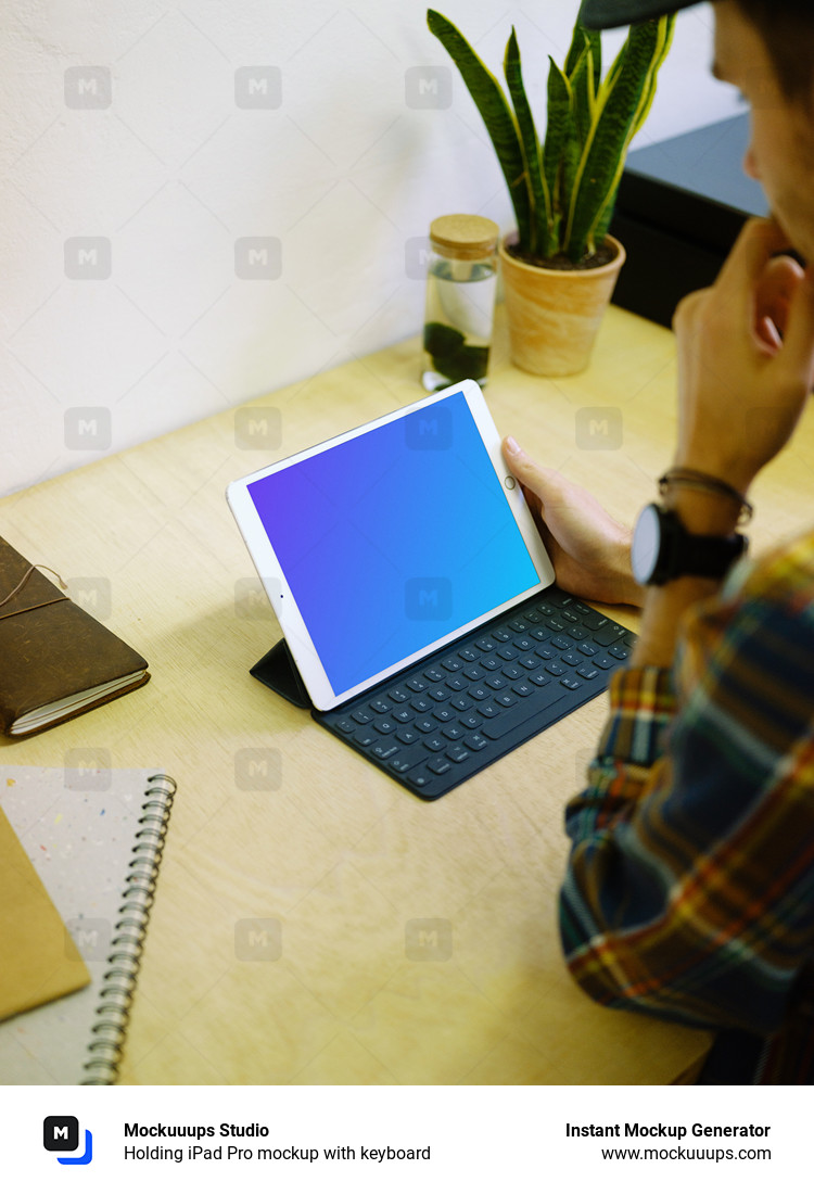 Holding iPad Pro mockup with keyboard