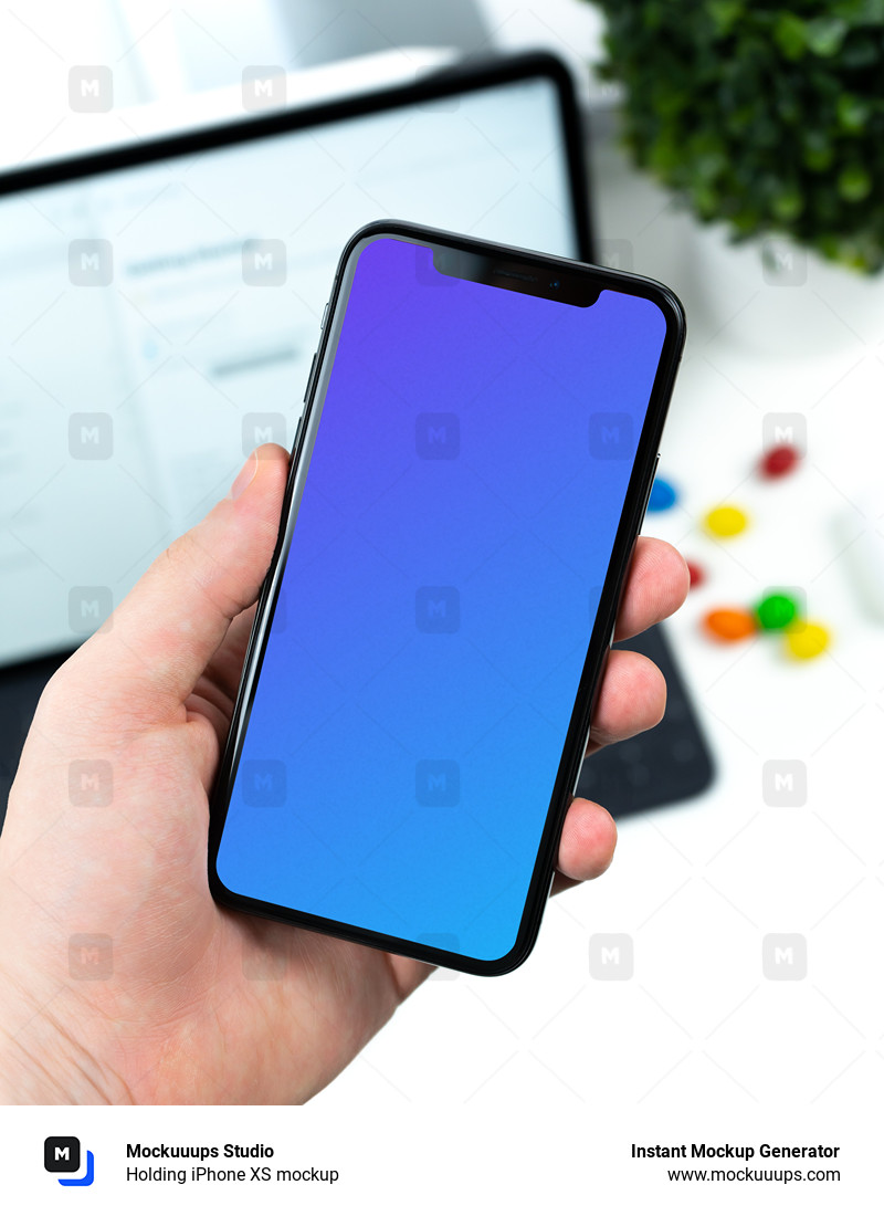 Holding iPhone XS mockup