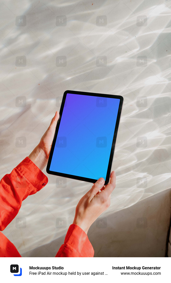 Free iPad Air mockup held by user against a bright silver background 