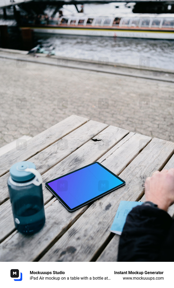 iPad Air mockup on a table with a bottle at the side 