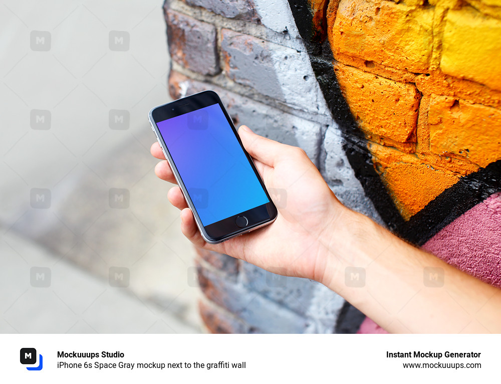 iPhone 6s Space Gray mockup next to the graffiti wall