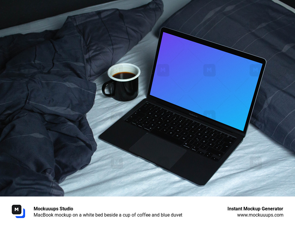 MacBook mockup on a white bed beside a cup of coffee and blue duvet 