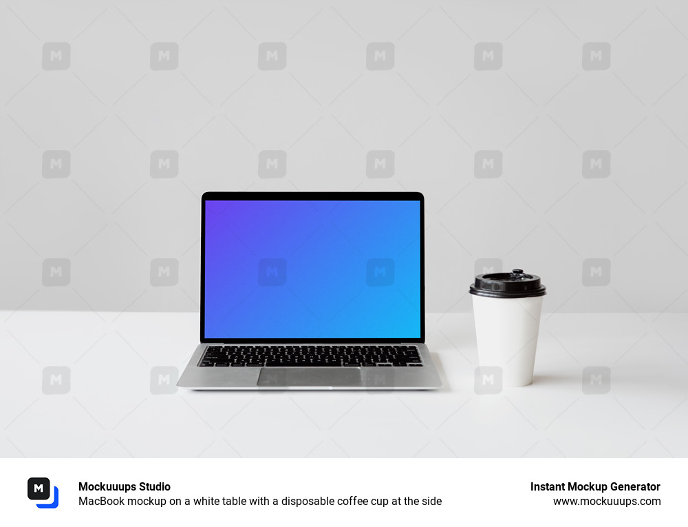 MacBook mockup on a white table with a disposable coffee cup at the side
