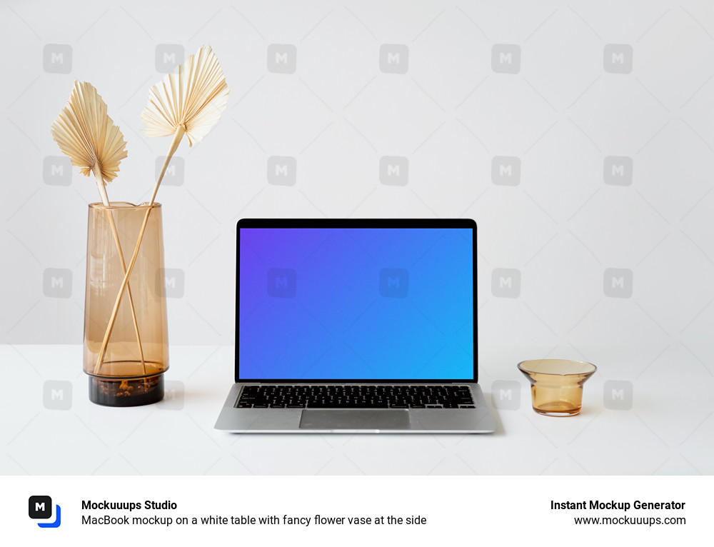 MacBook mockup on a white table with fancy flower vase at the side