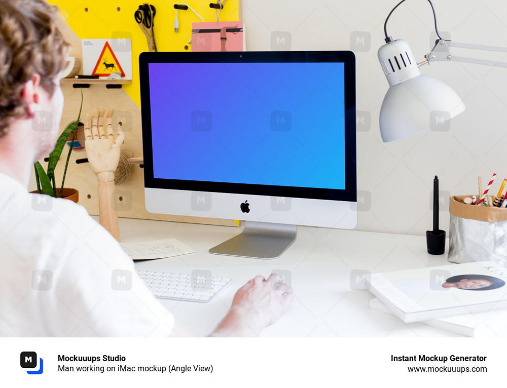 Man working on iMac mockup (Angle View)