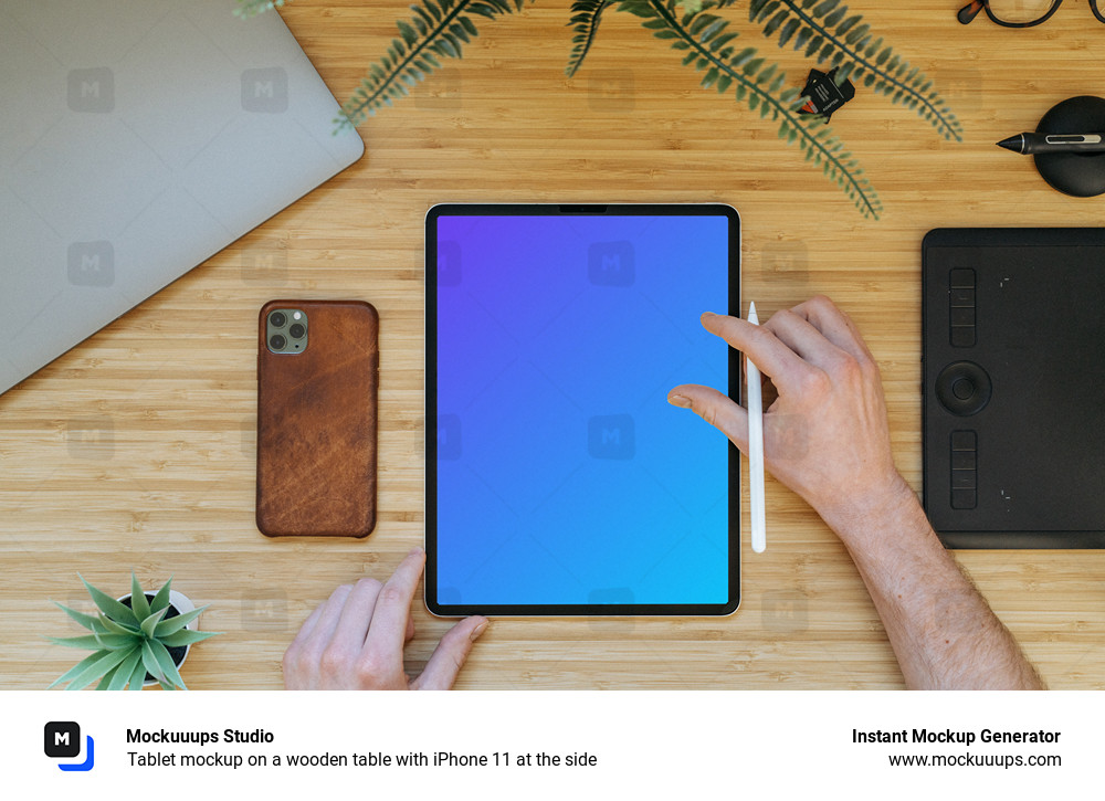 Tablet mockup on a wooden table with iPhone 11 at the side