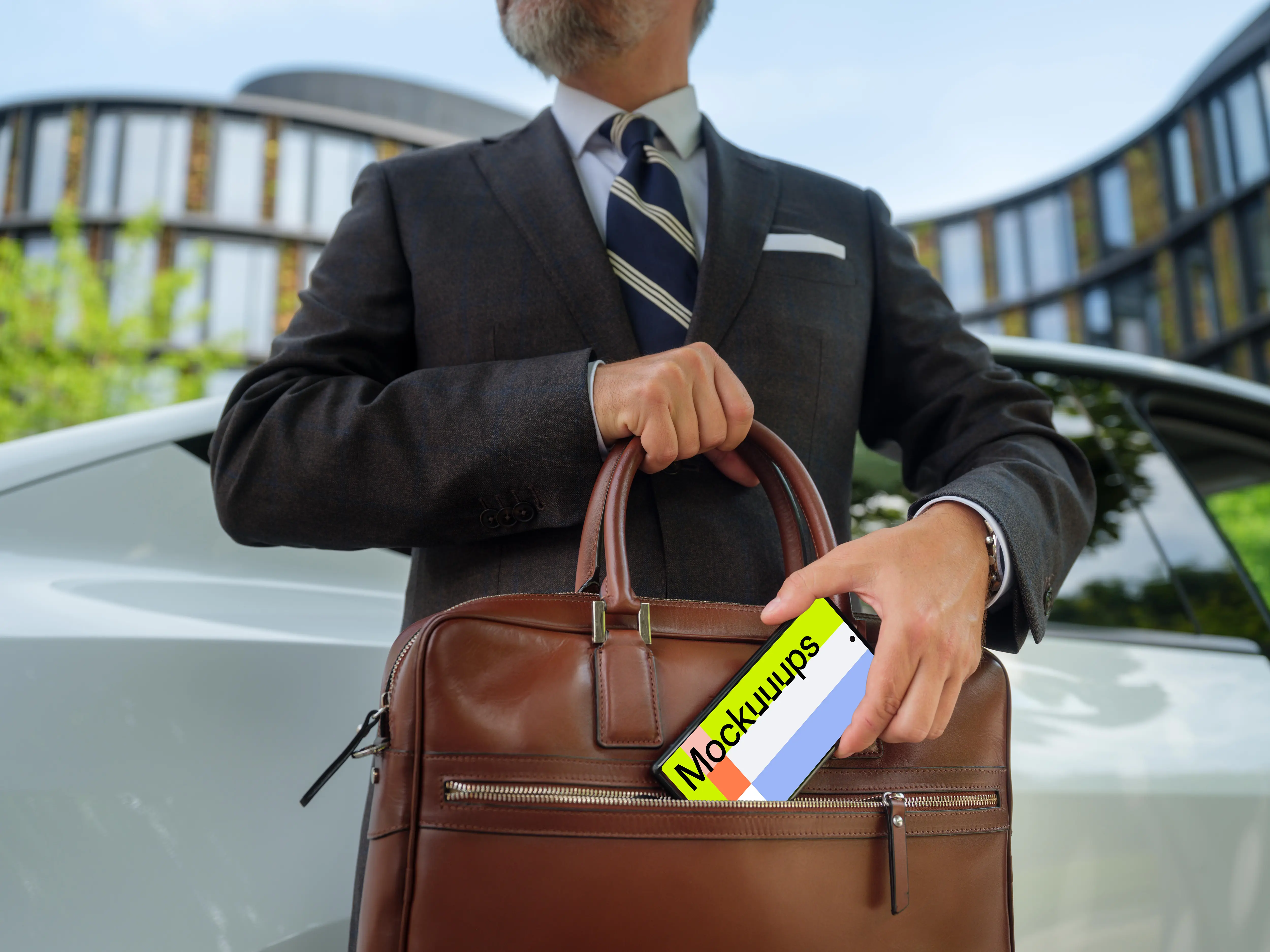 Businessman putting his phone into the work bag