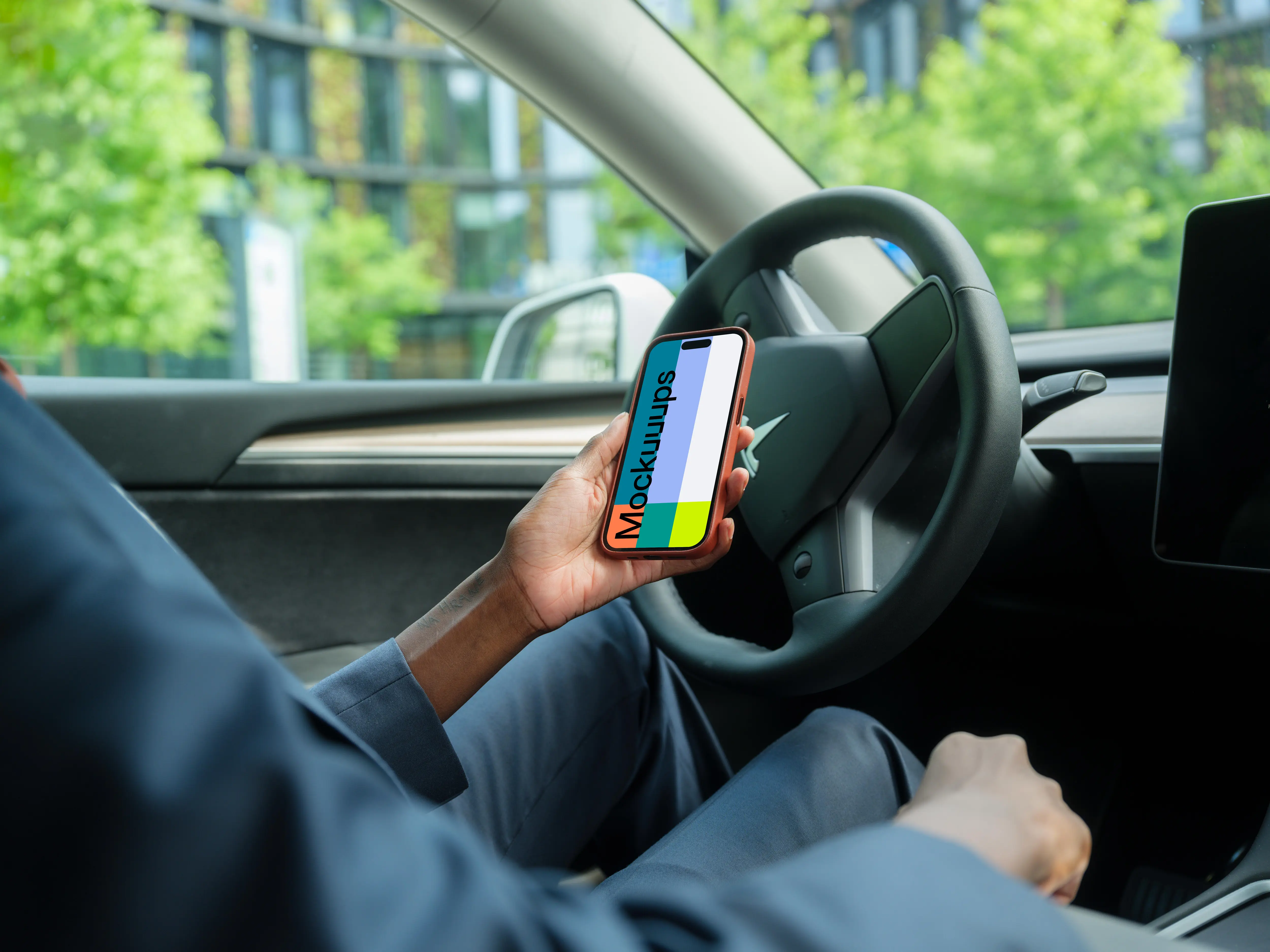 Businesswoman thriving in Tesla with iPhone 14 Pro