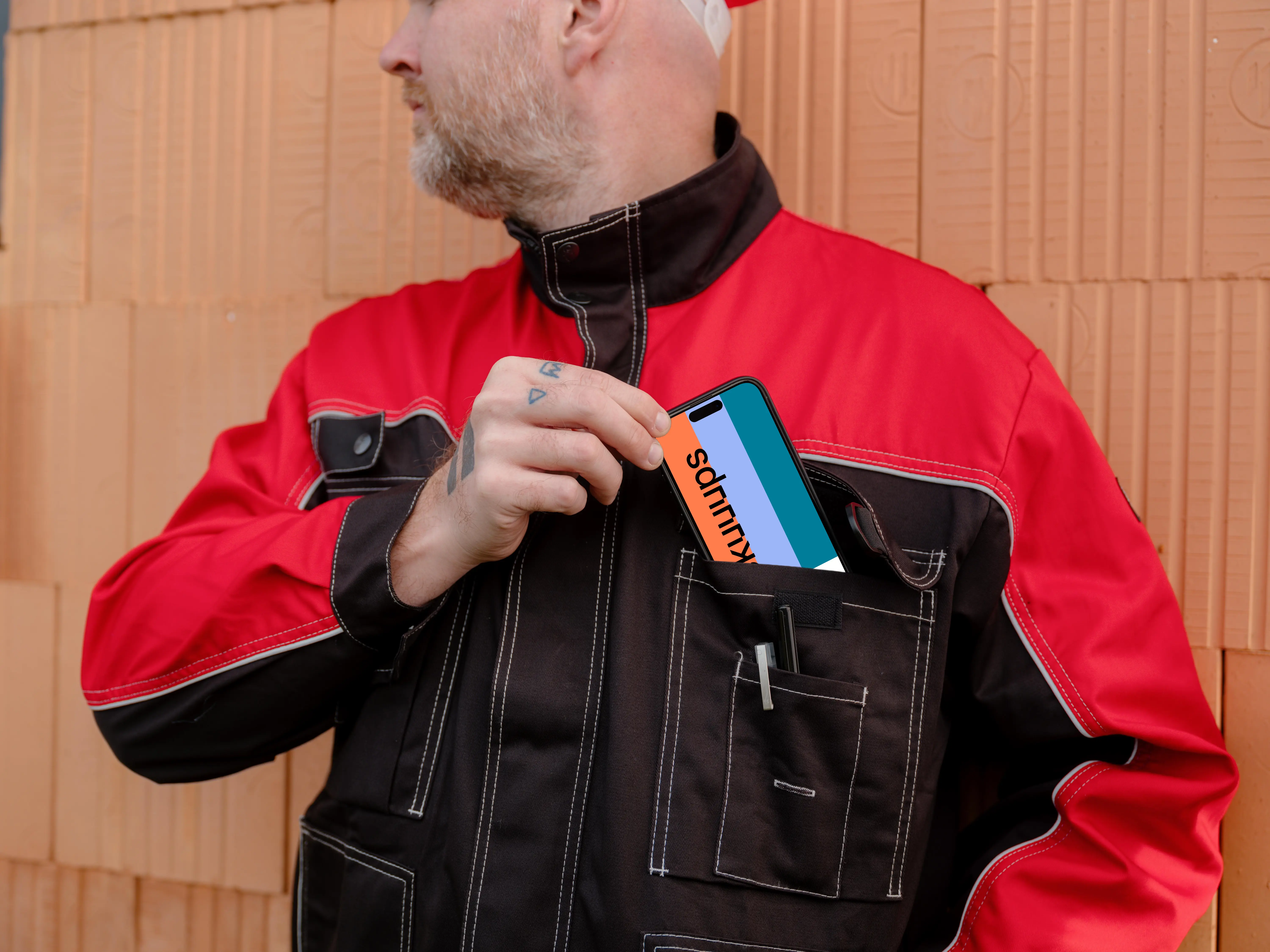 Construction worker with a phone in his pocket