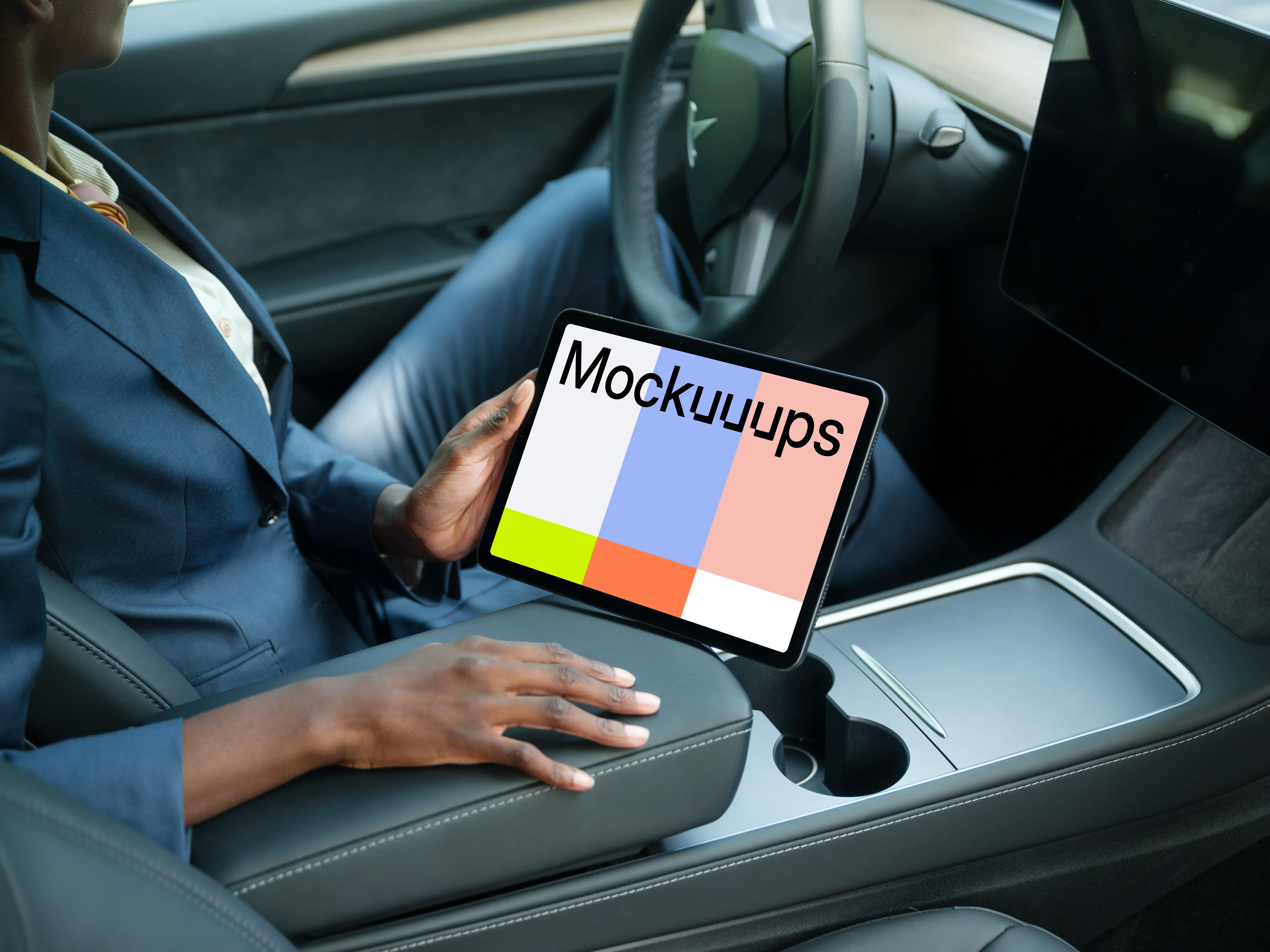 Entrepreneur holding an iPad Air mockup in Tesla