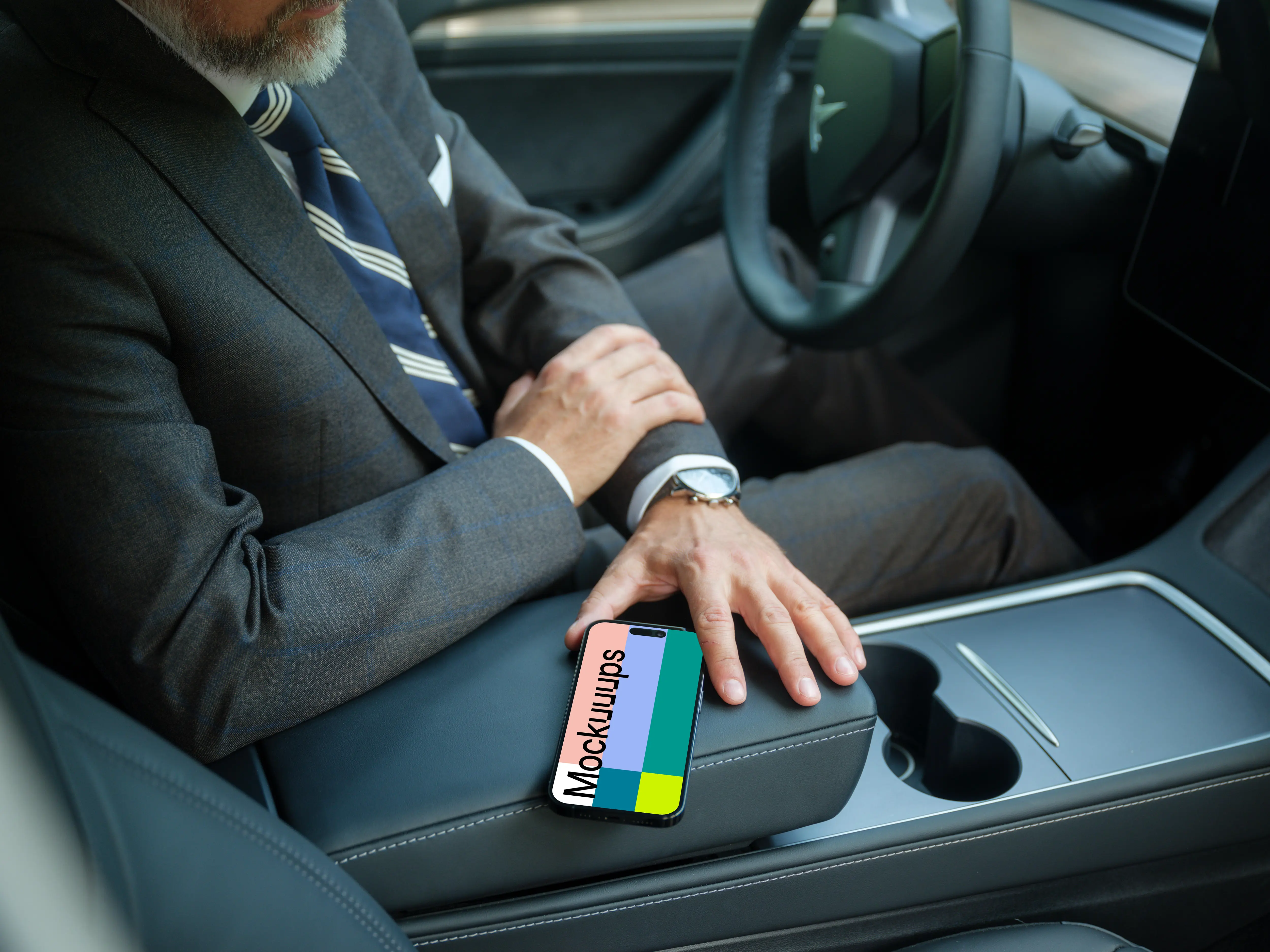 Entrepreneur sitting in Tesla with iPhone mockup