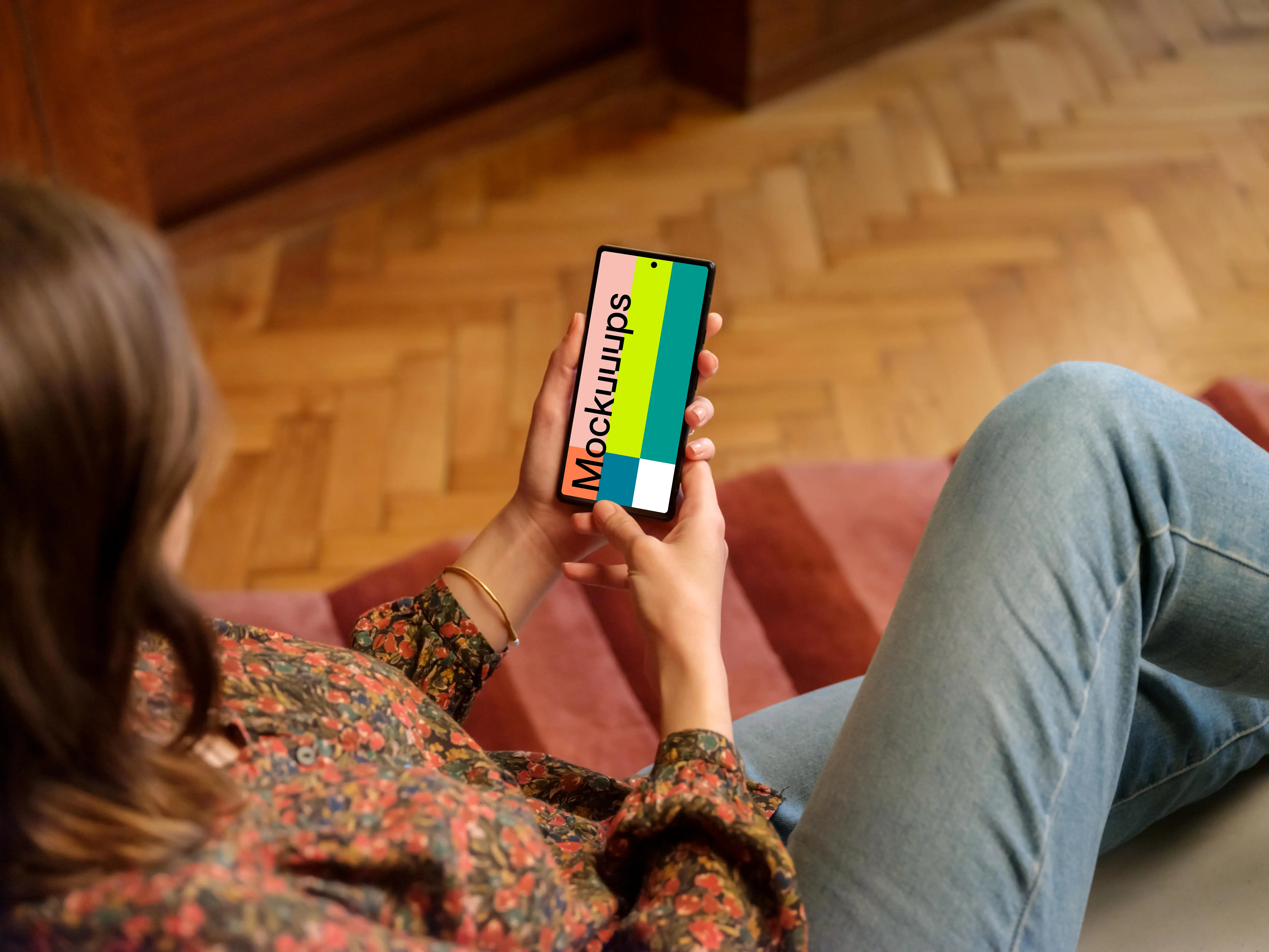 Female displaying Google Pixel mockup in wooden ambience of the lounge