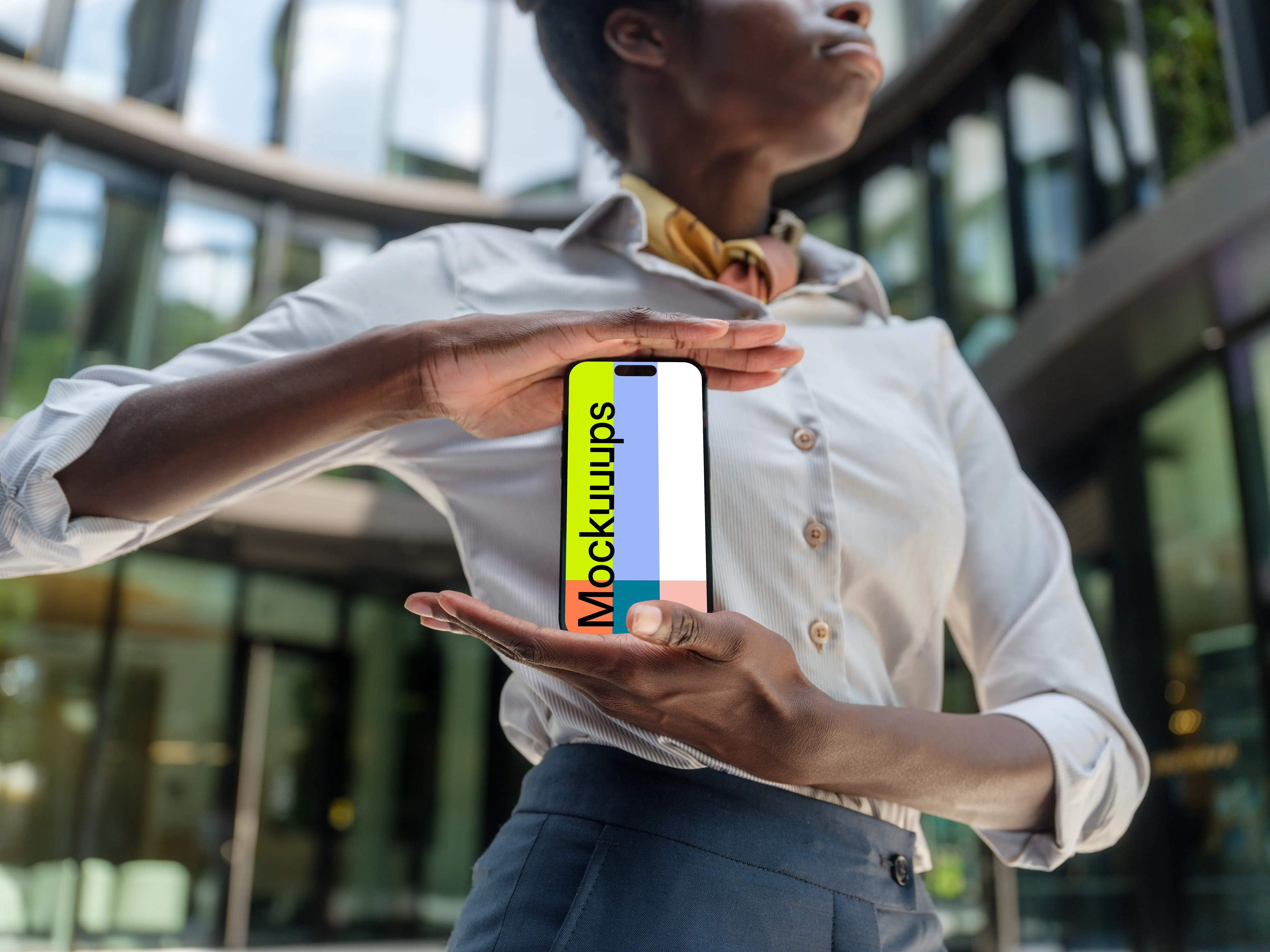 Female entrepreneur standing in front of company with an iPhone