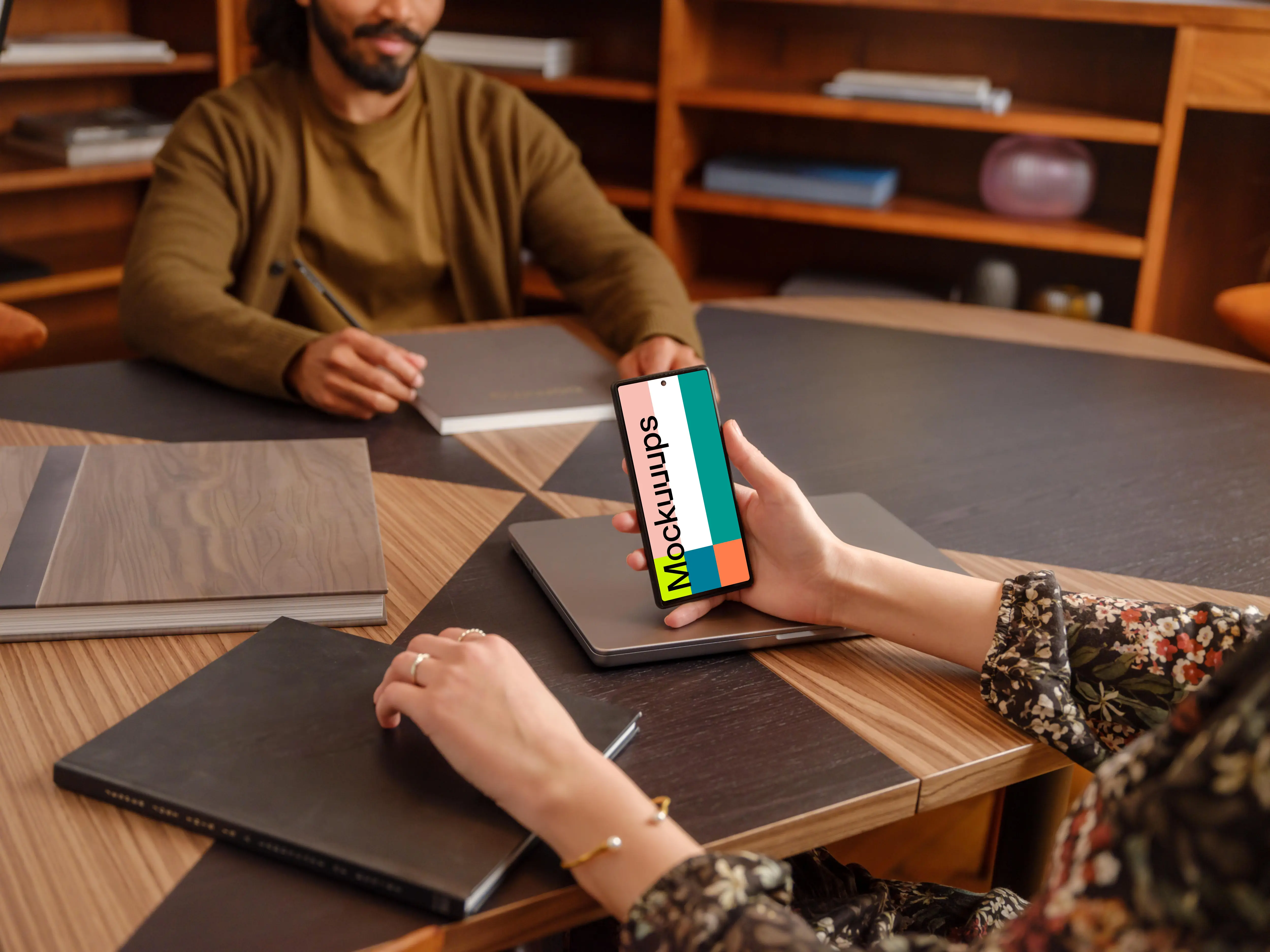 Female hand holding a Google Pixel 6 mockup in the office