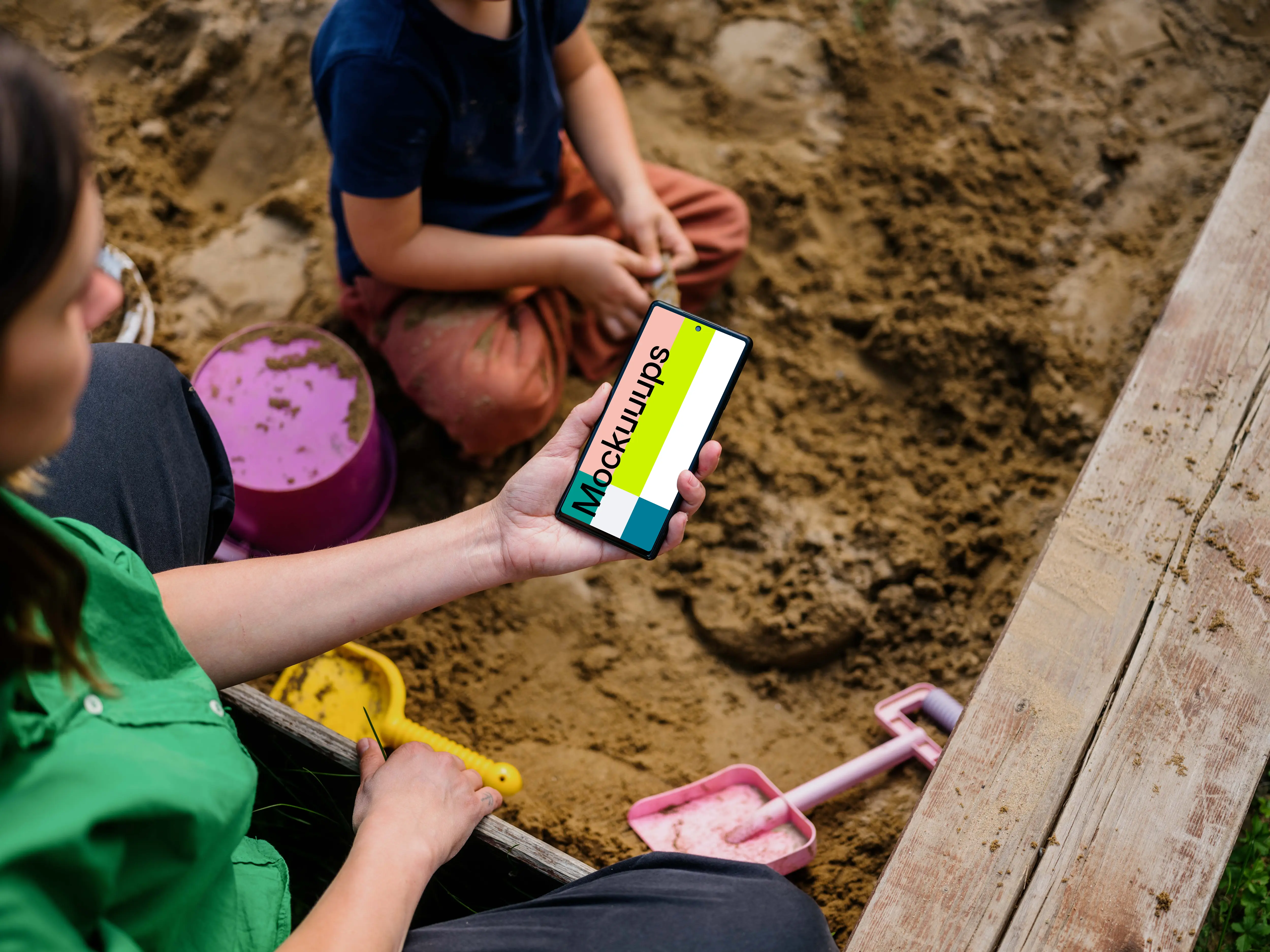 Female holding a Google Pixel in sandpit mockup