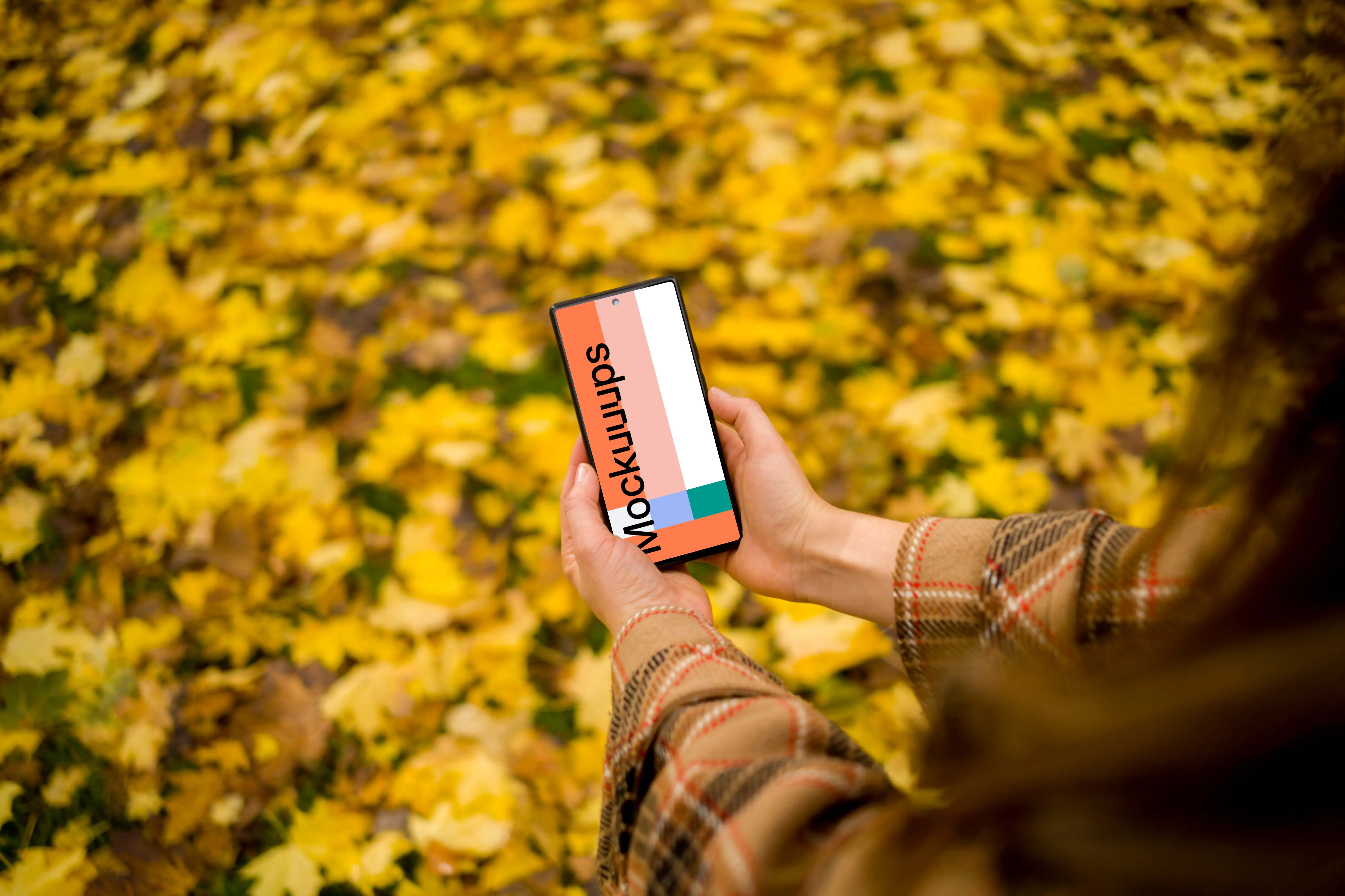 Female holding a phone mockup with autumn vibe