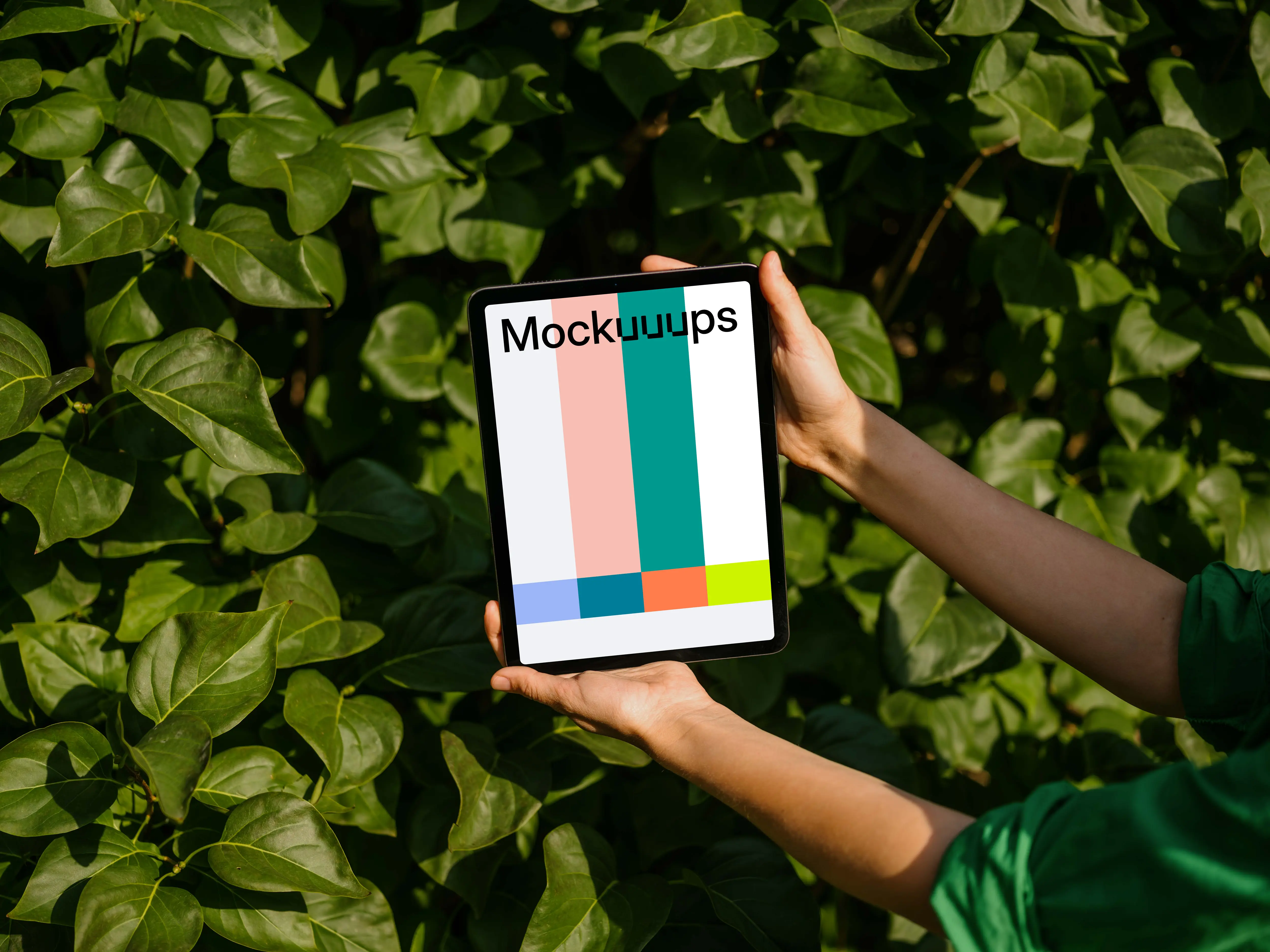 Female holding an iPad Air mockup in front of plant leaves