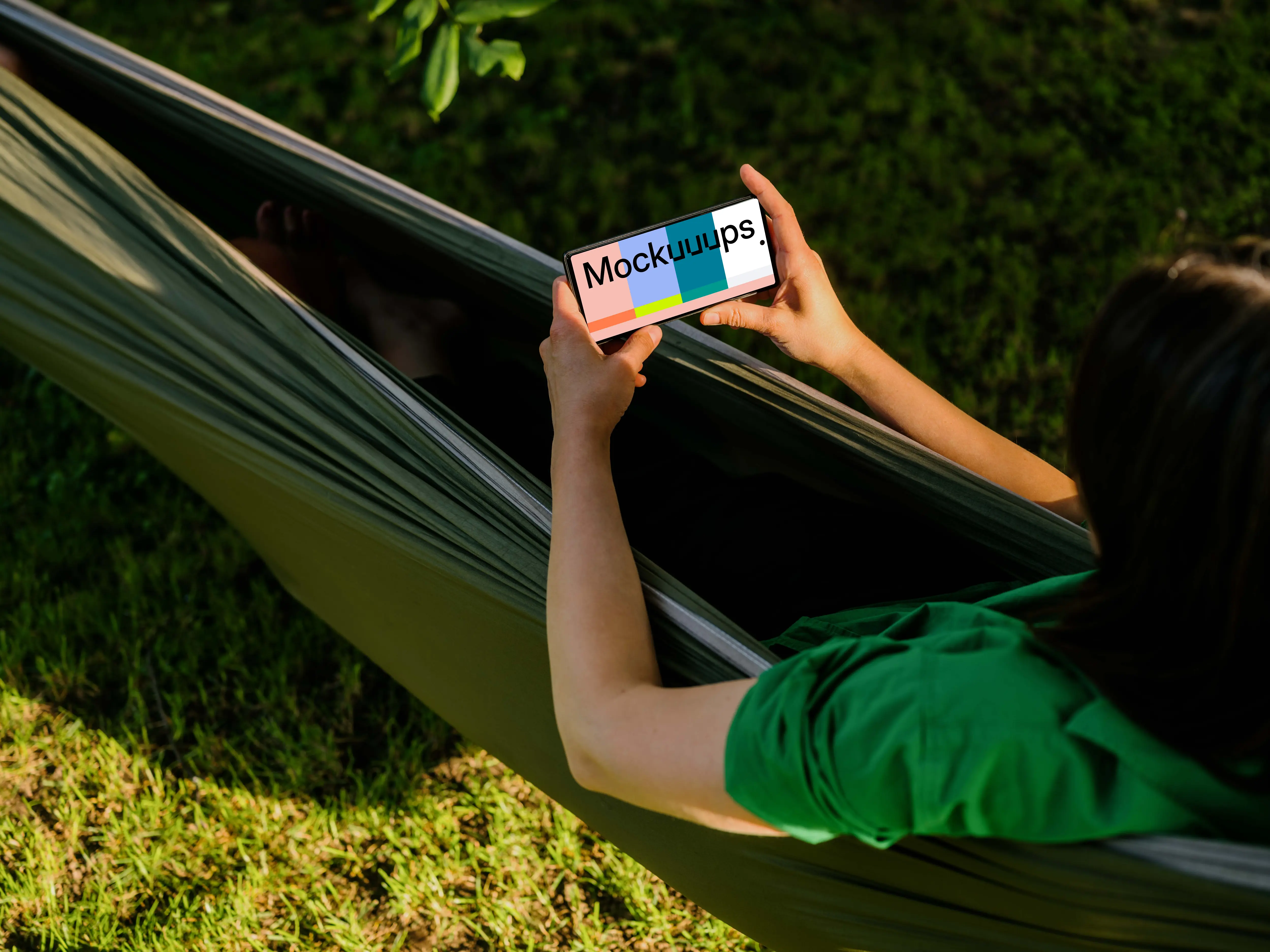 Female laying in a hammock while holding a Google Pixel 6 mockup