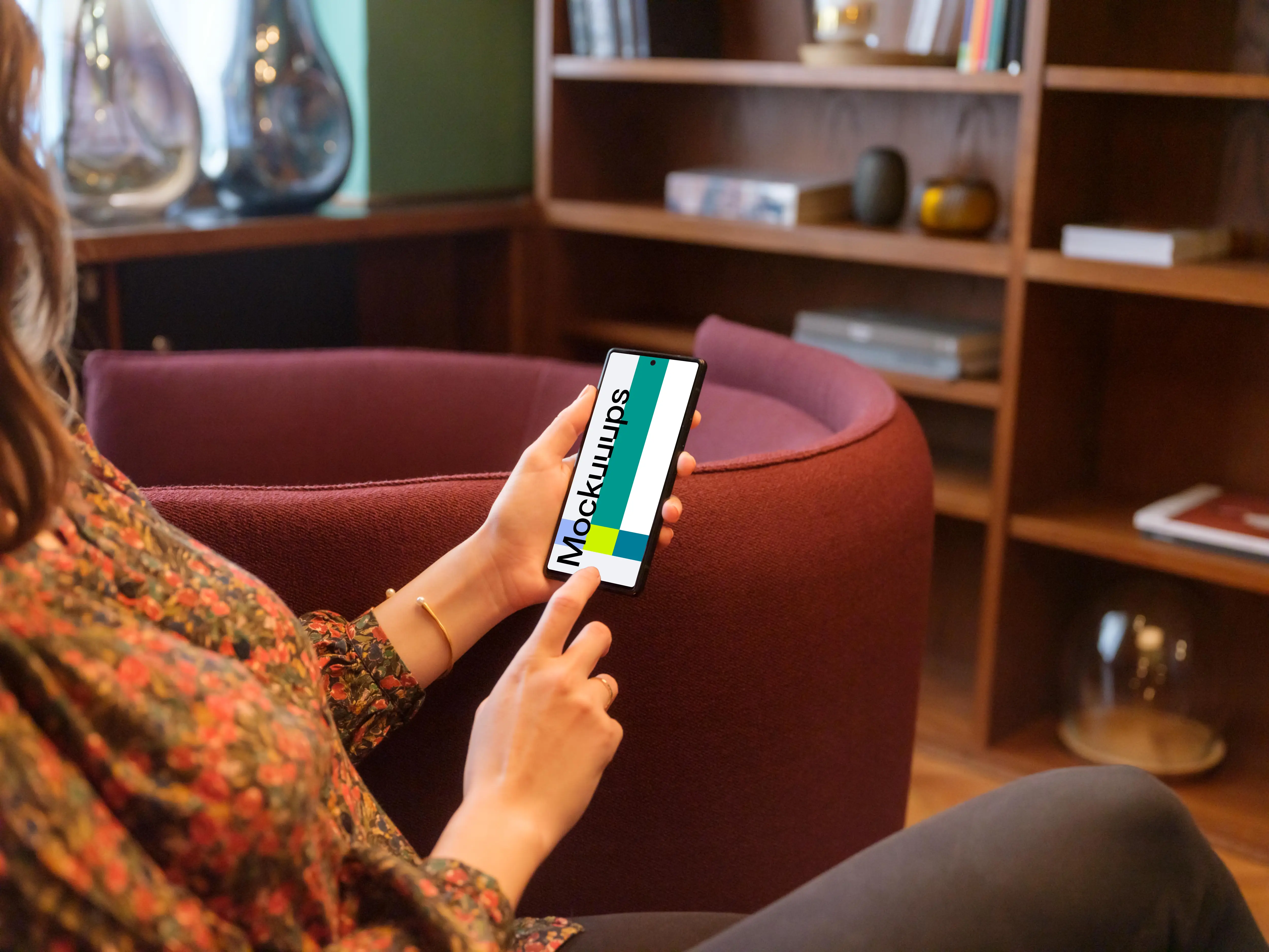 Female working on a Google Pixel mockup in a lounge area