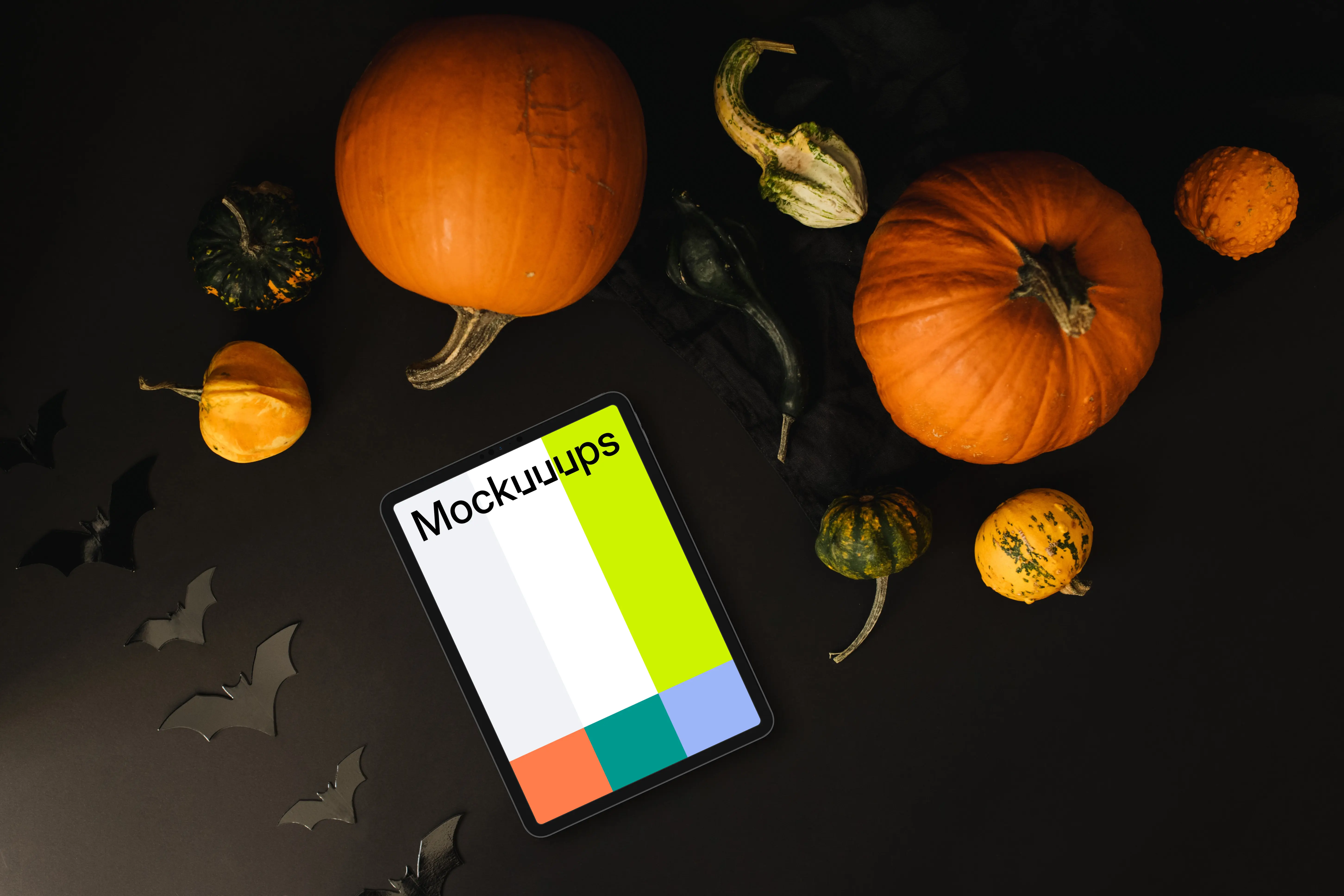 Halloween pumpkin mockup with a tablet on the dark background