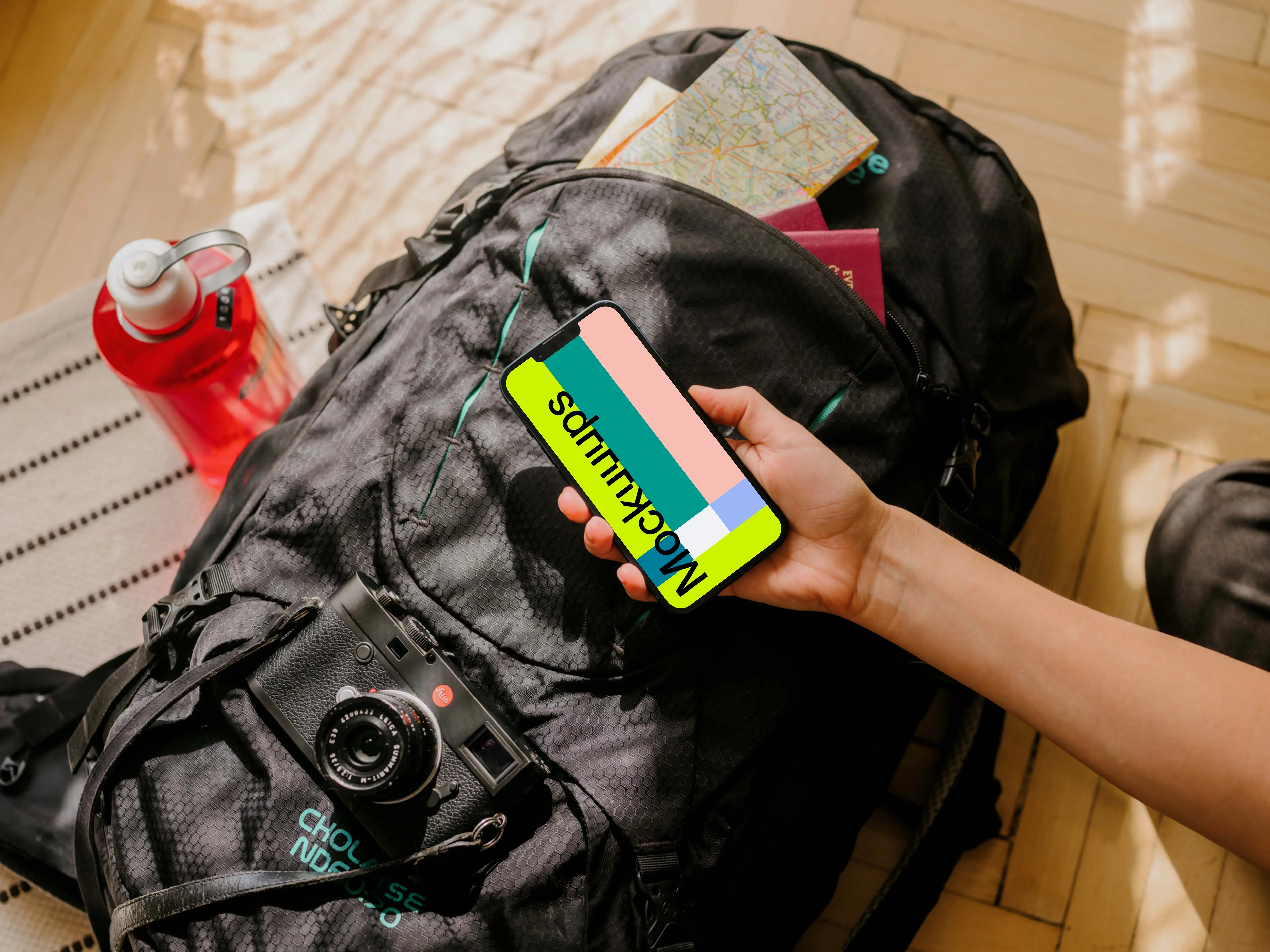 Hand holding an iPhone mockup