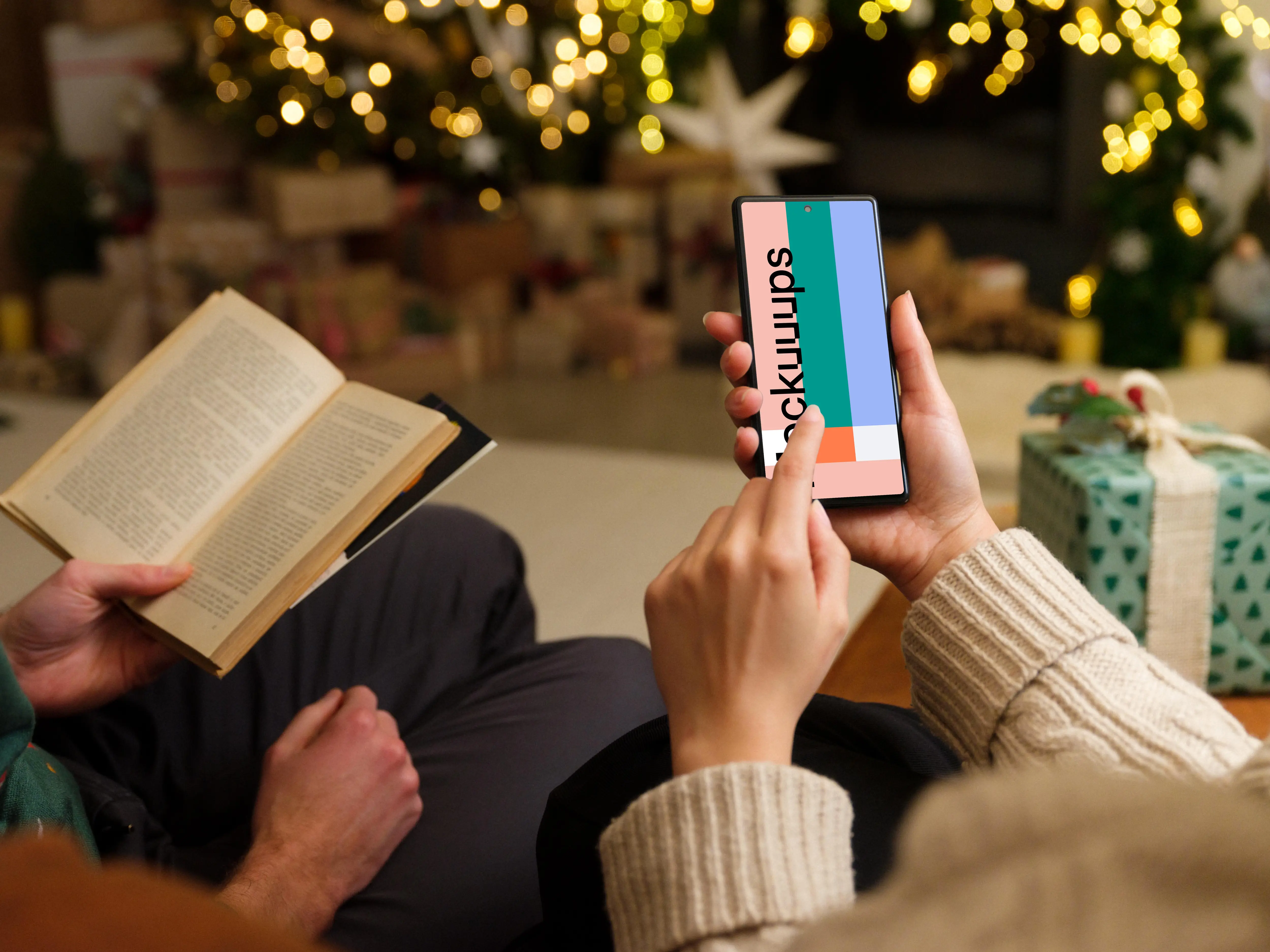 Hand typing on a phone mockup in Christmas theme