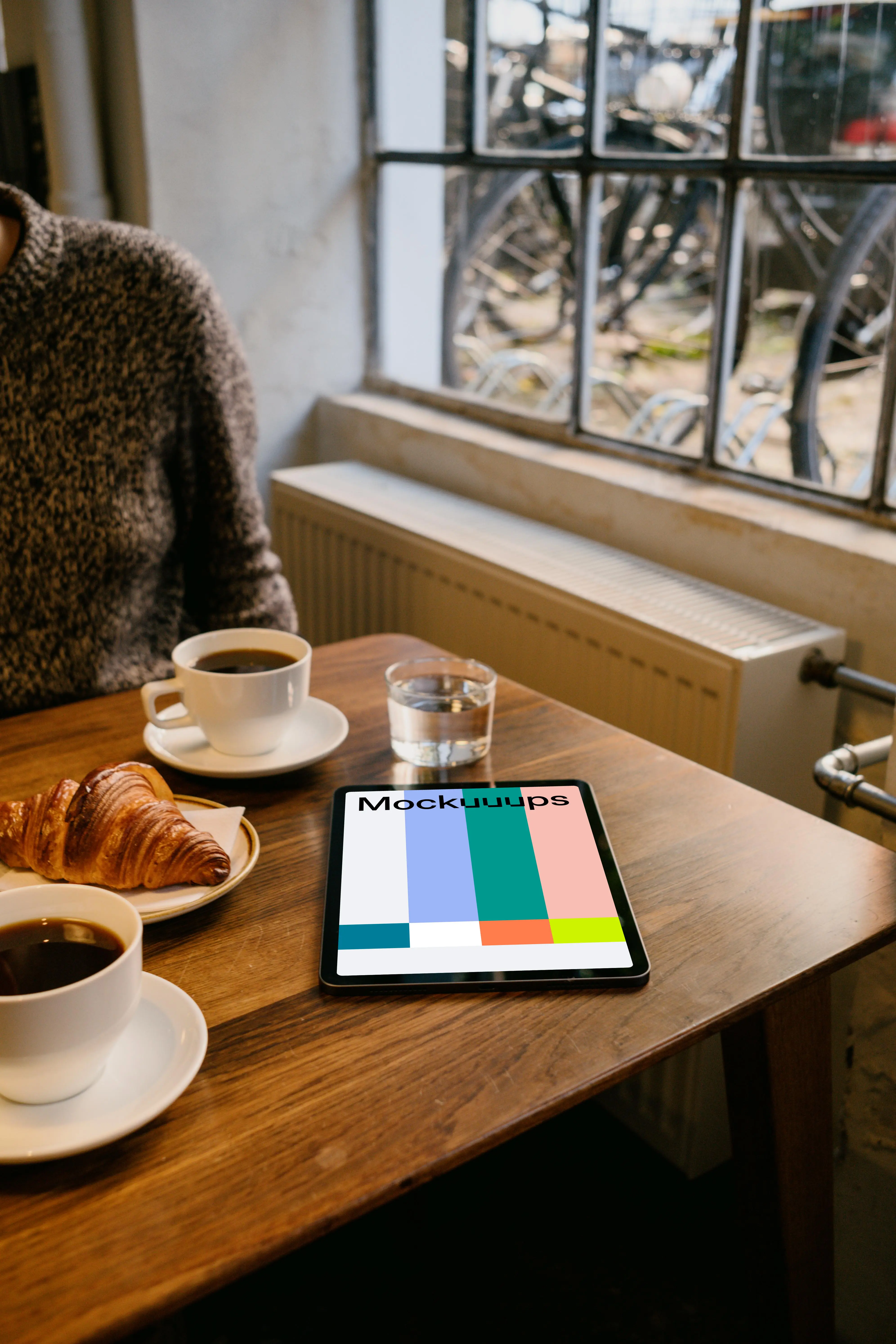 iPad Air mockup on a brown table with a plate of food at the side