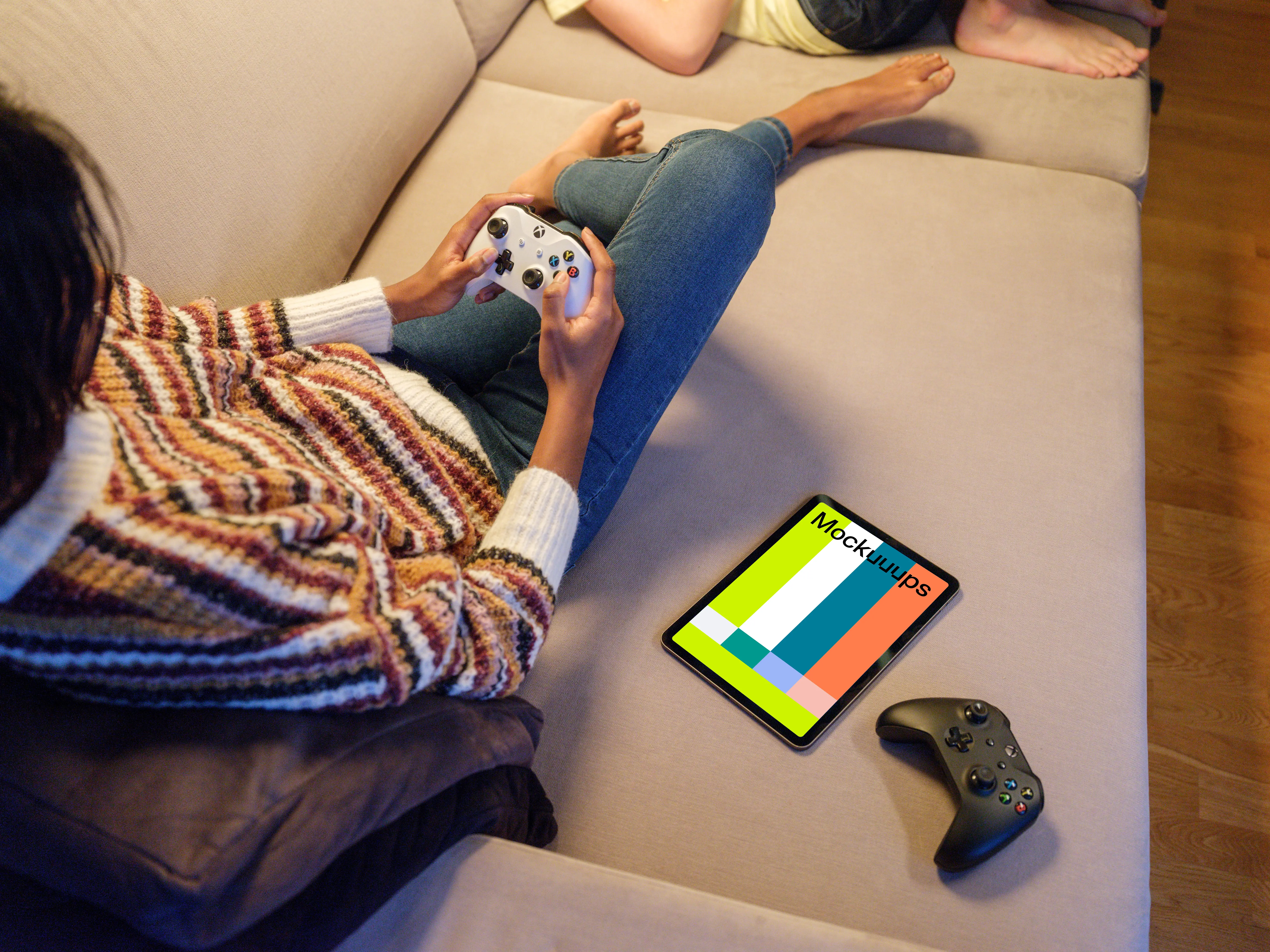 iPad Air mockup with gaming controllers on a sofa