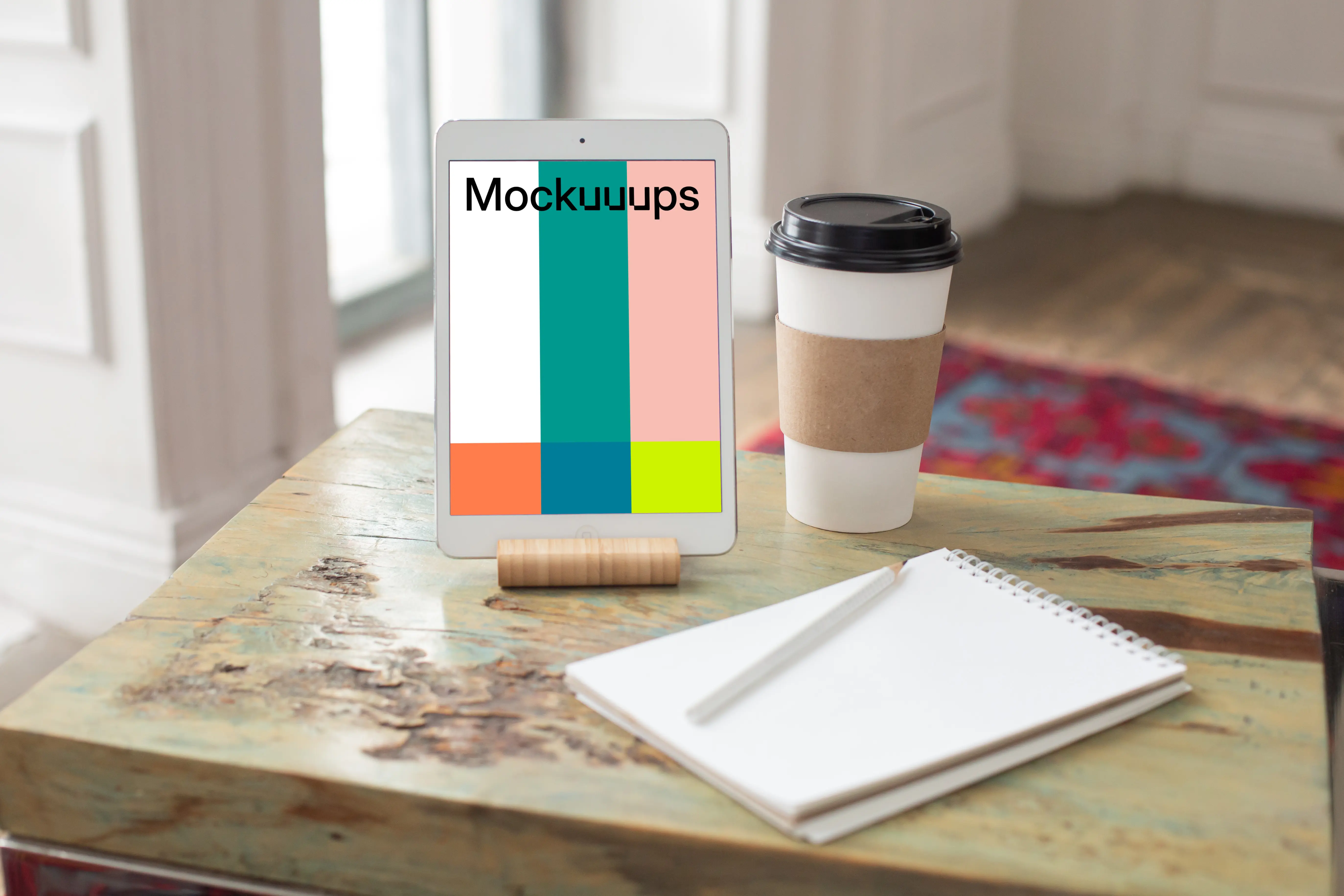  iPad Mini mockup beside a cup of coffee and a notepad