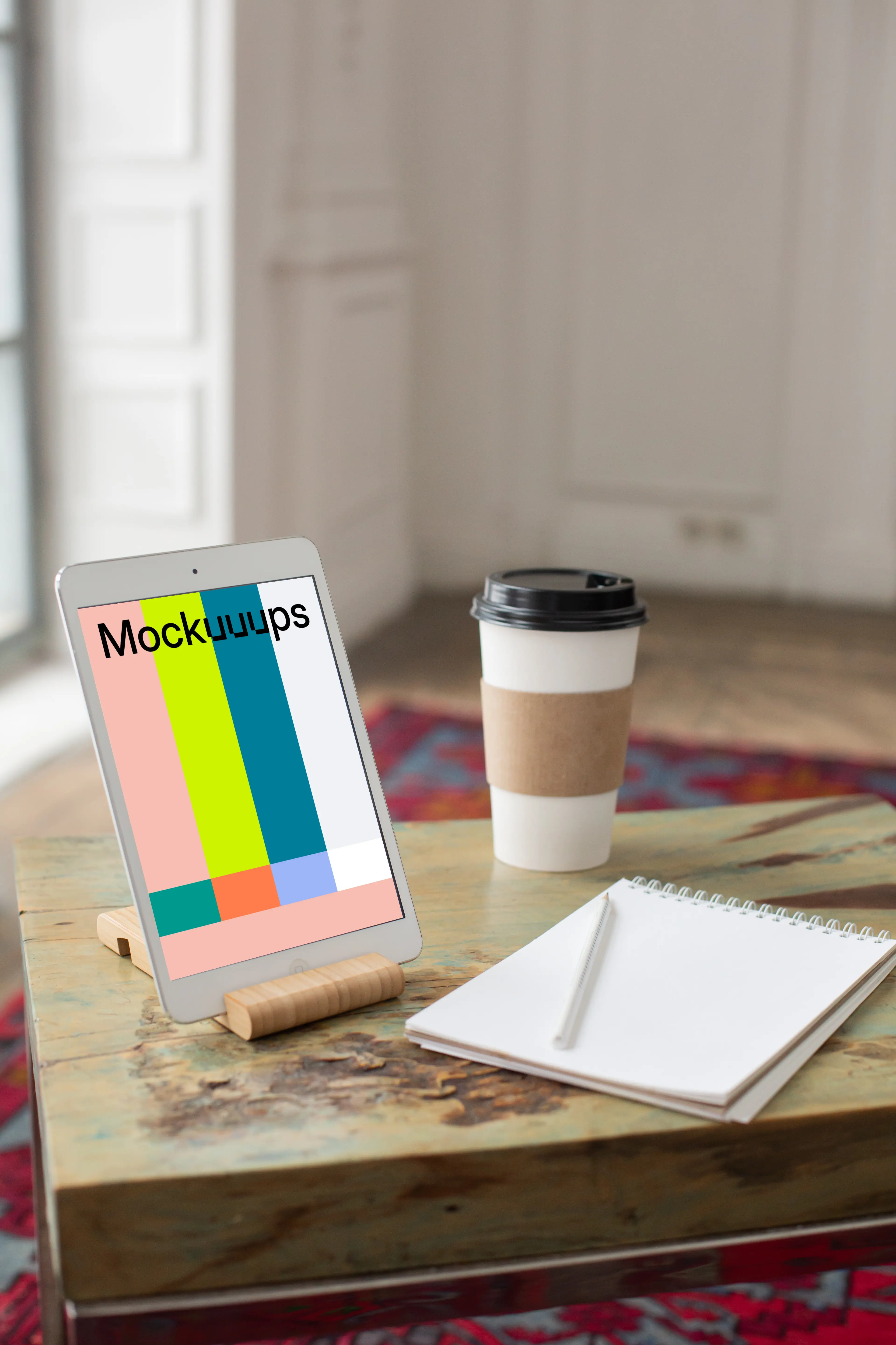 iPad Mini mockup beside a notepad