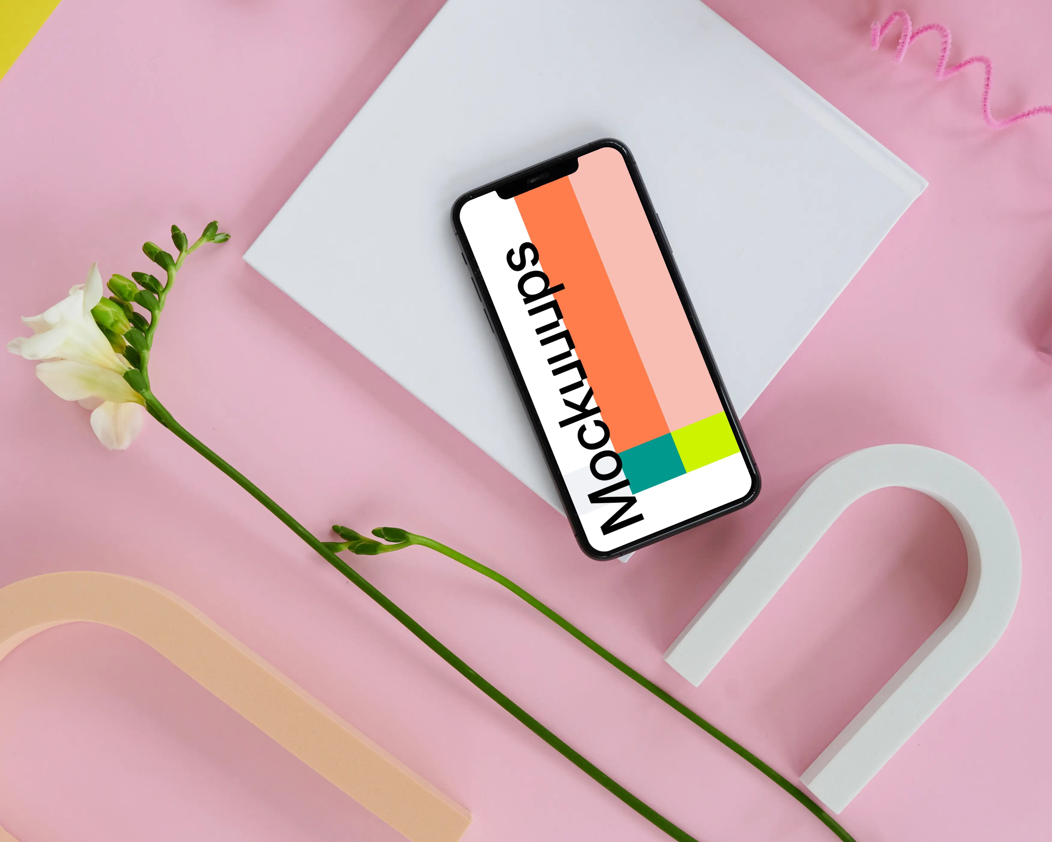 iPhone 11 mockup on a pink table