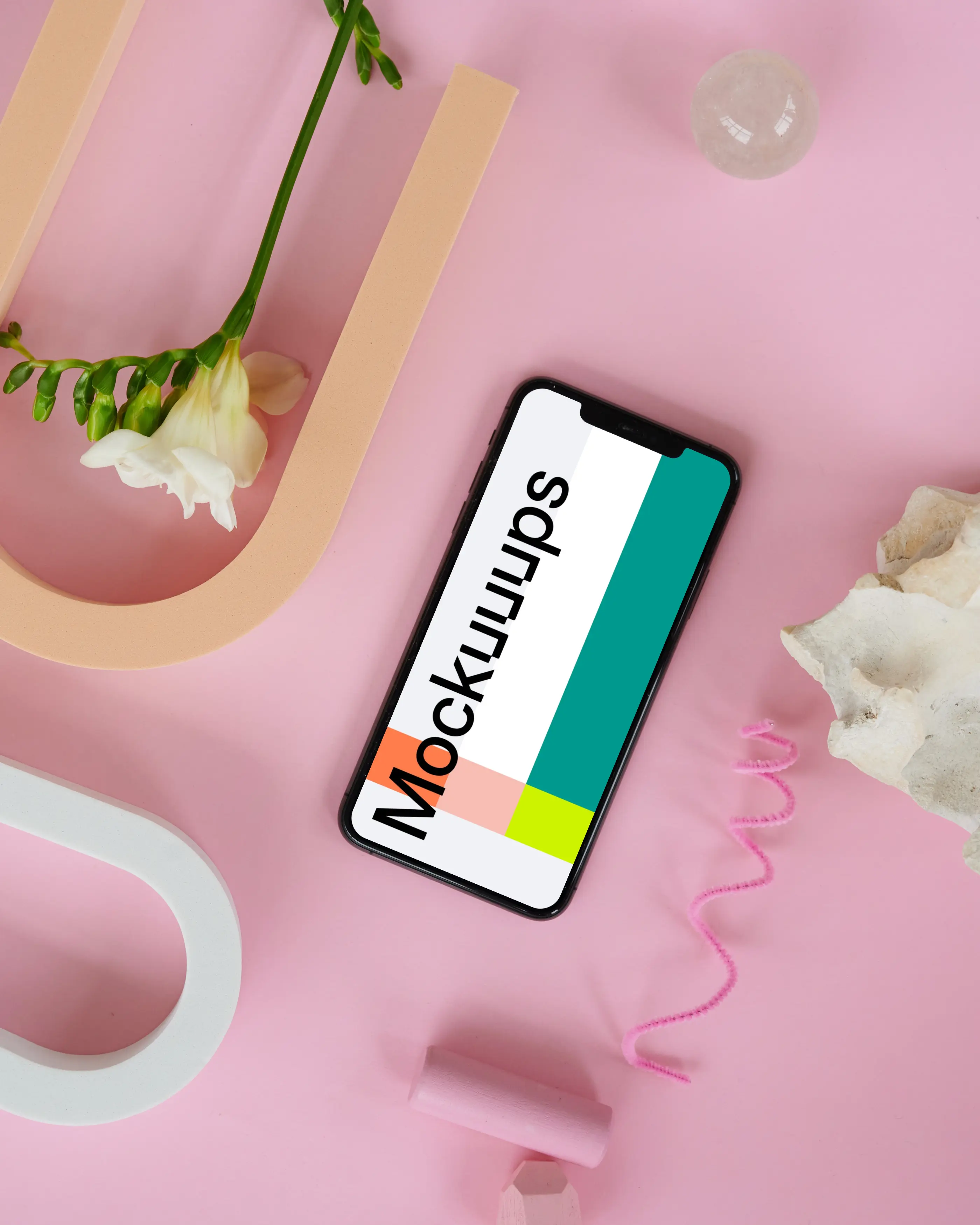 iPhone 12 mockup on a pink table