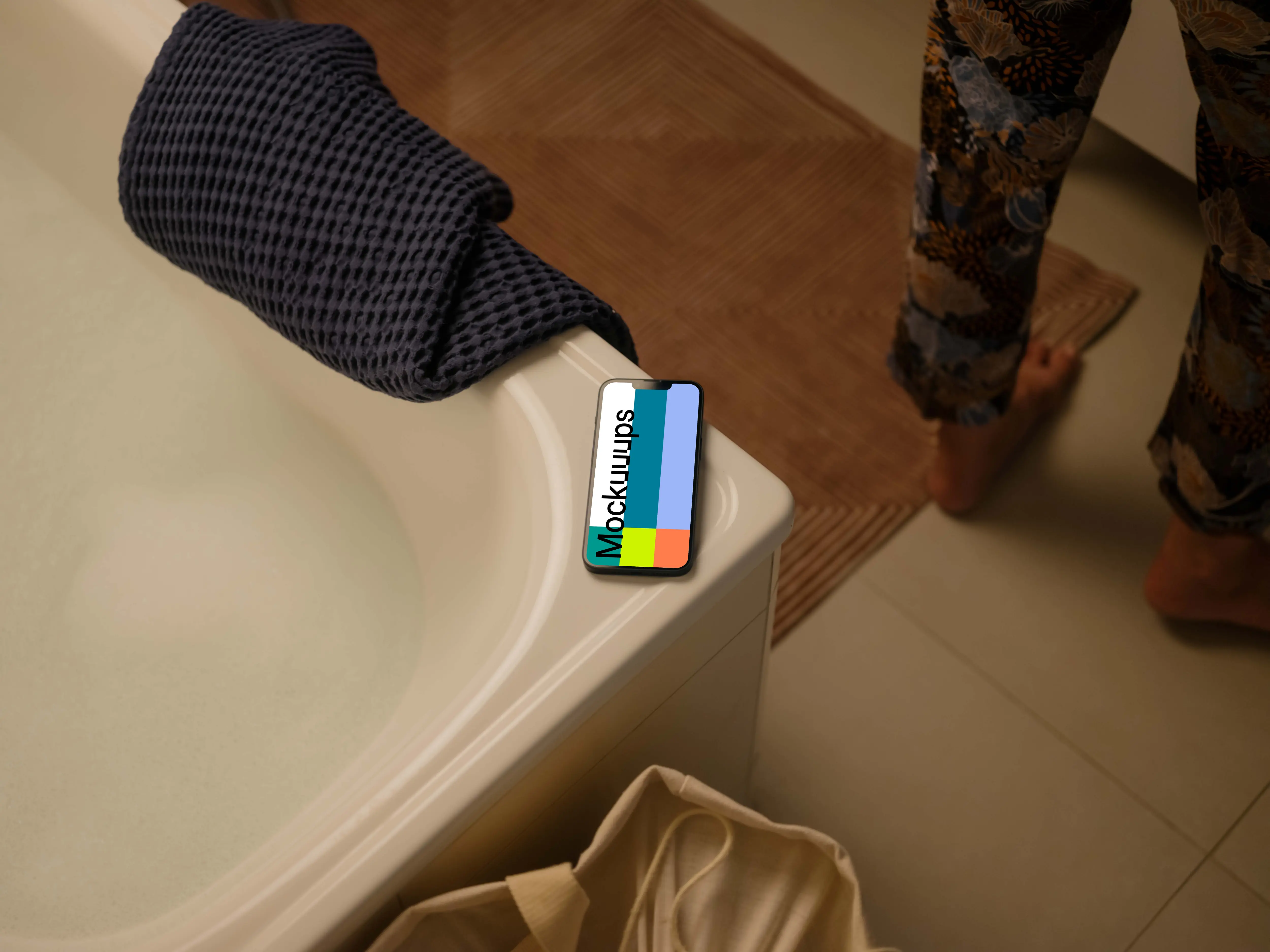 iPhone 13 mockup on an edge of a bathtub