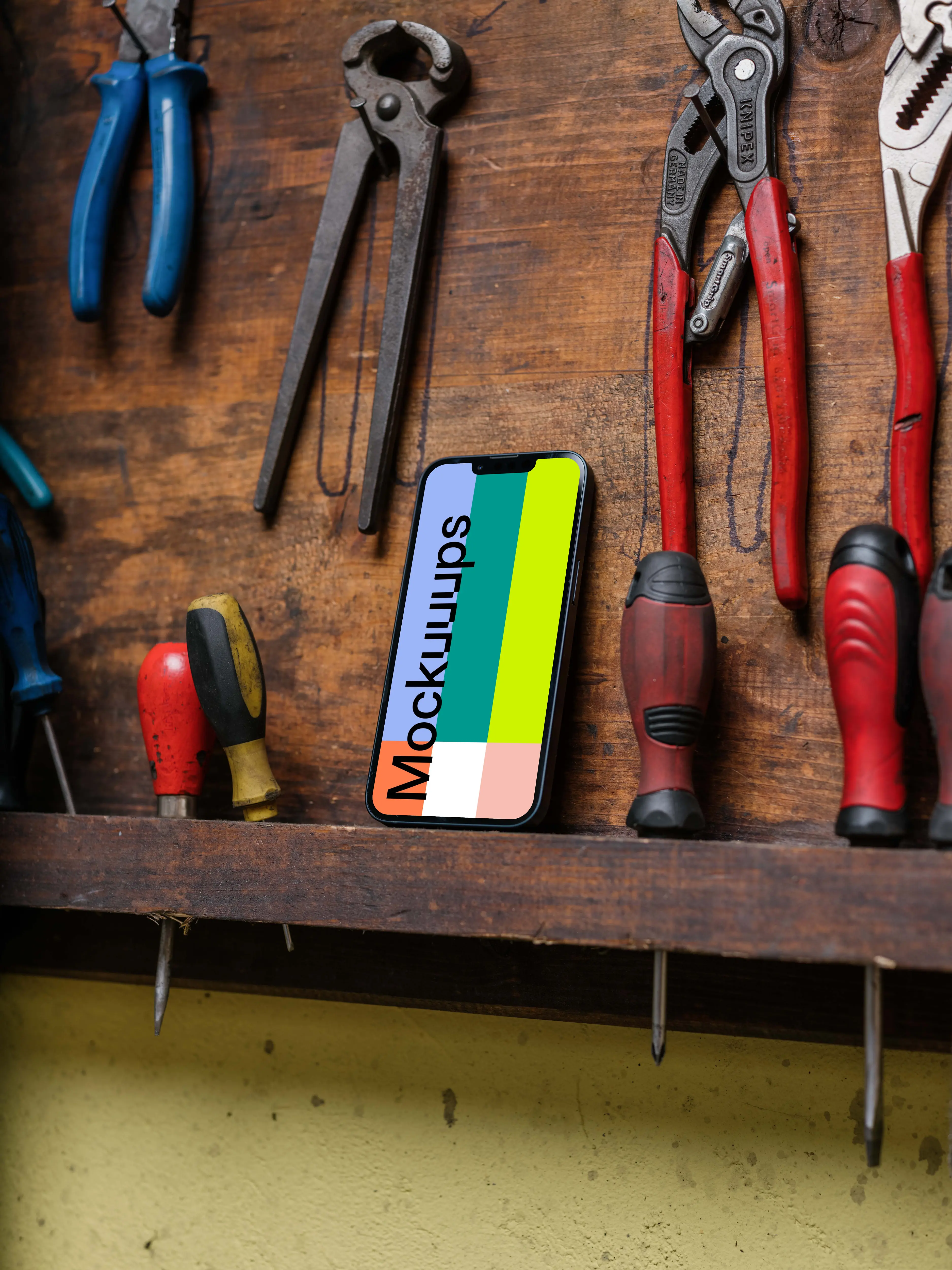 iPhone 13 Pro mockup beside work tools