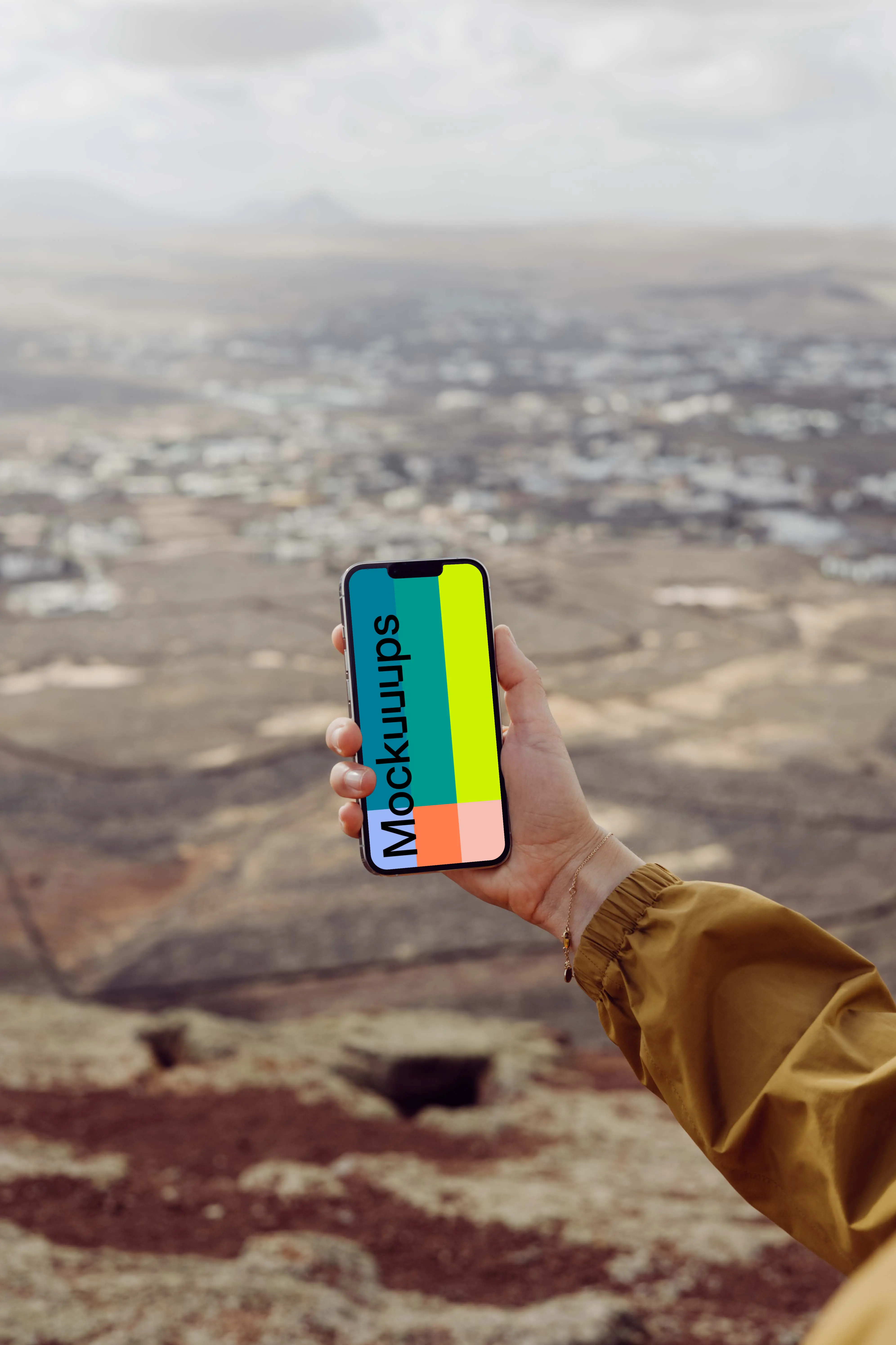  iPhone 13 Pro mockup held by a user from a high location.