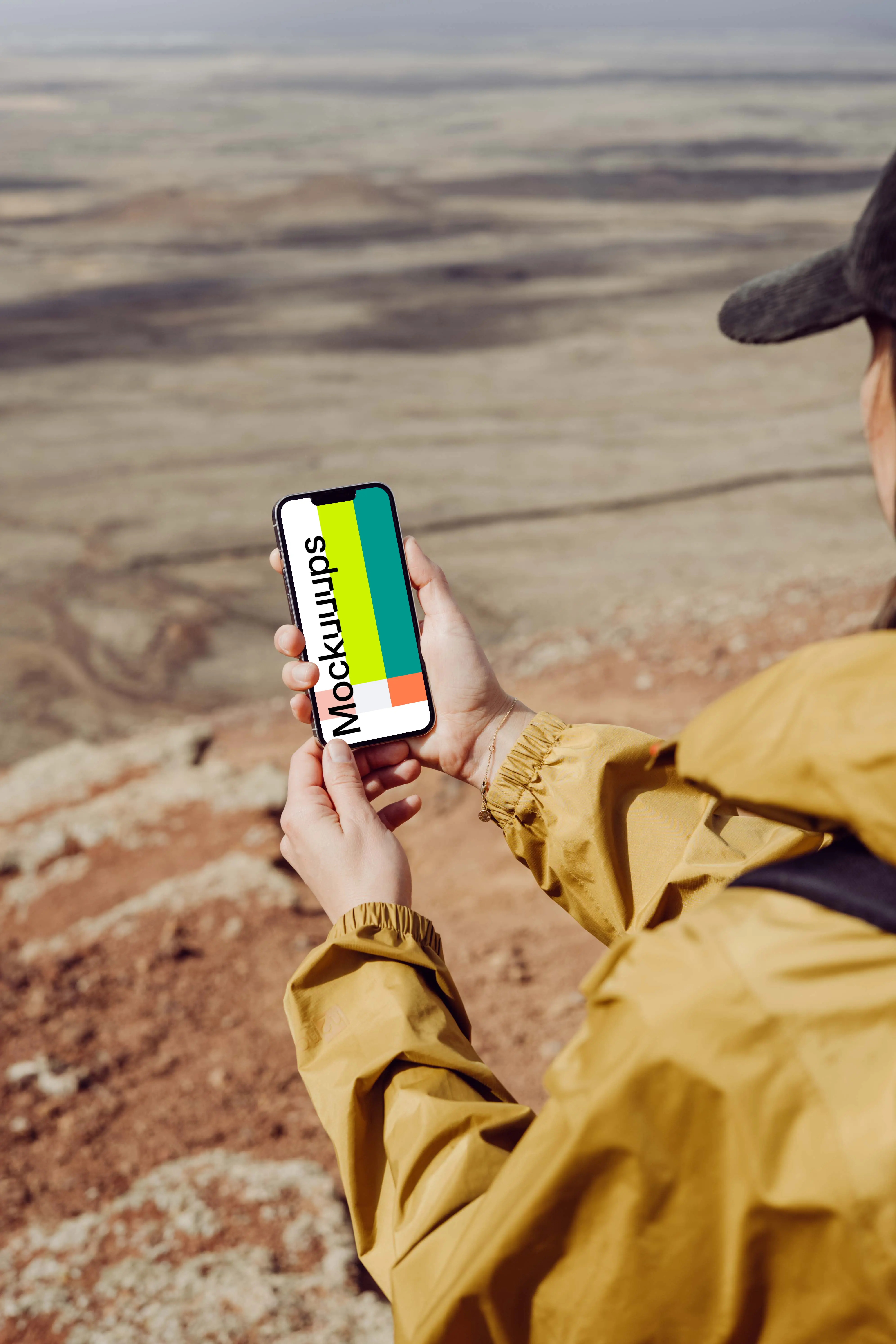 iPhone 13 Pro mockup held by a user on a sandy beach