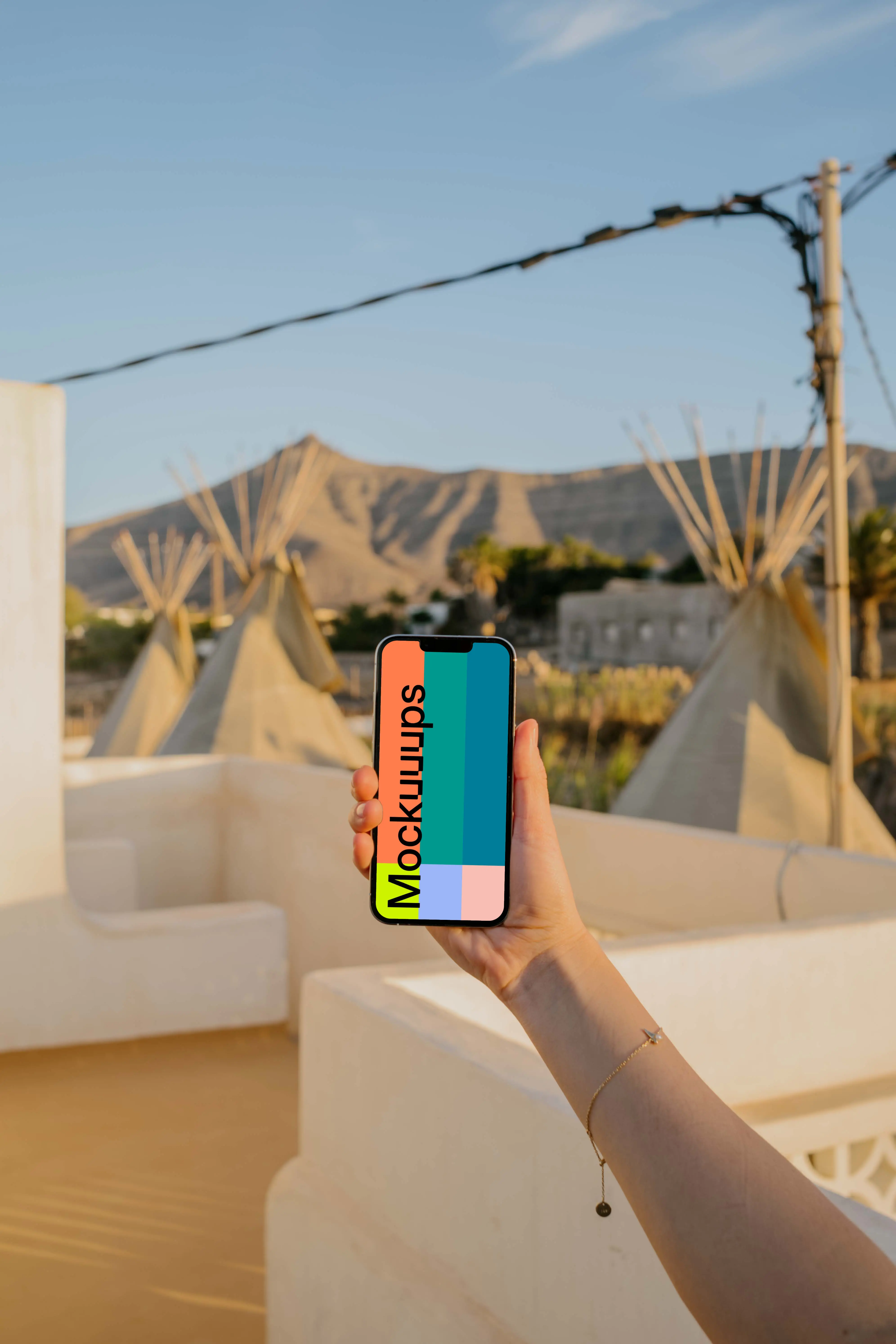iPhone 13 Pro mockup held by a user outdoors in the sun