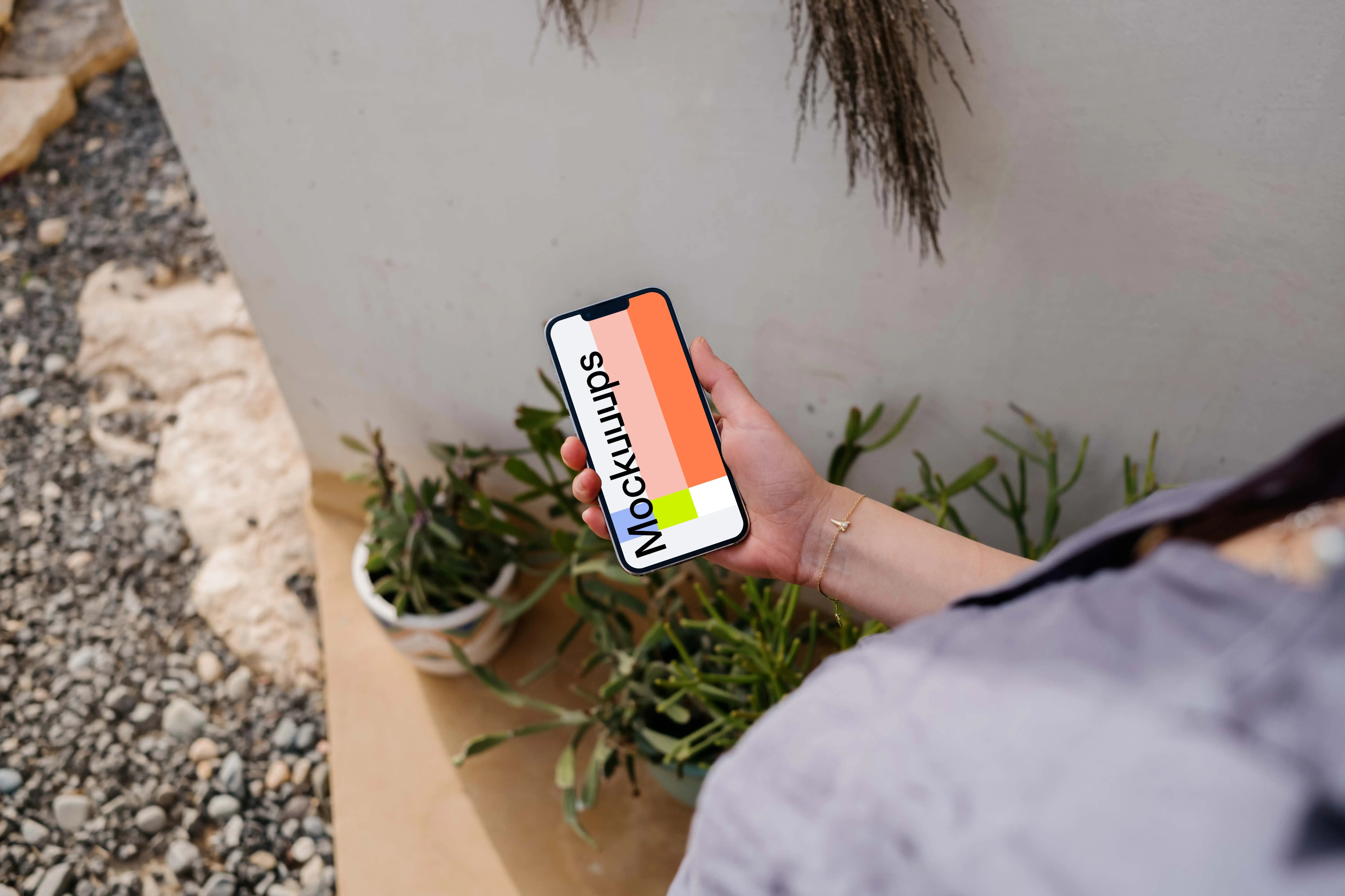 iPhone 13 Pro mockup held by a user outdoors