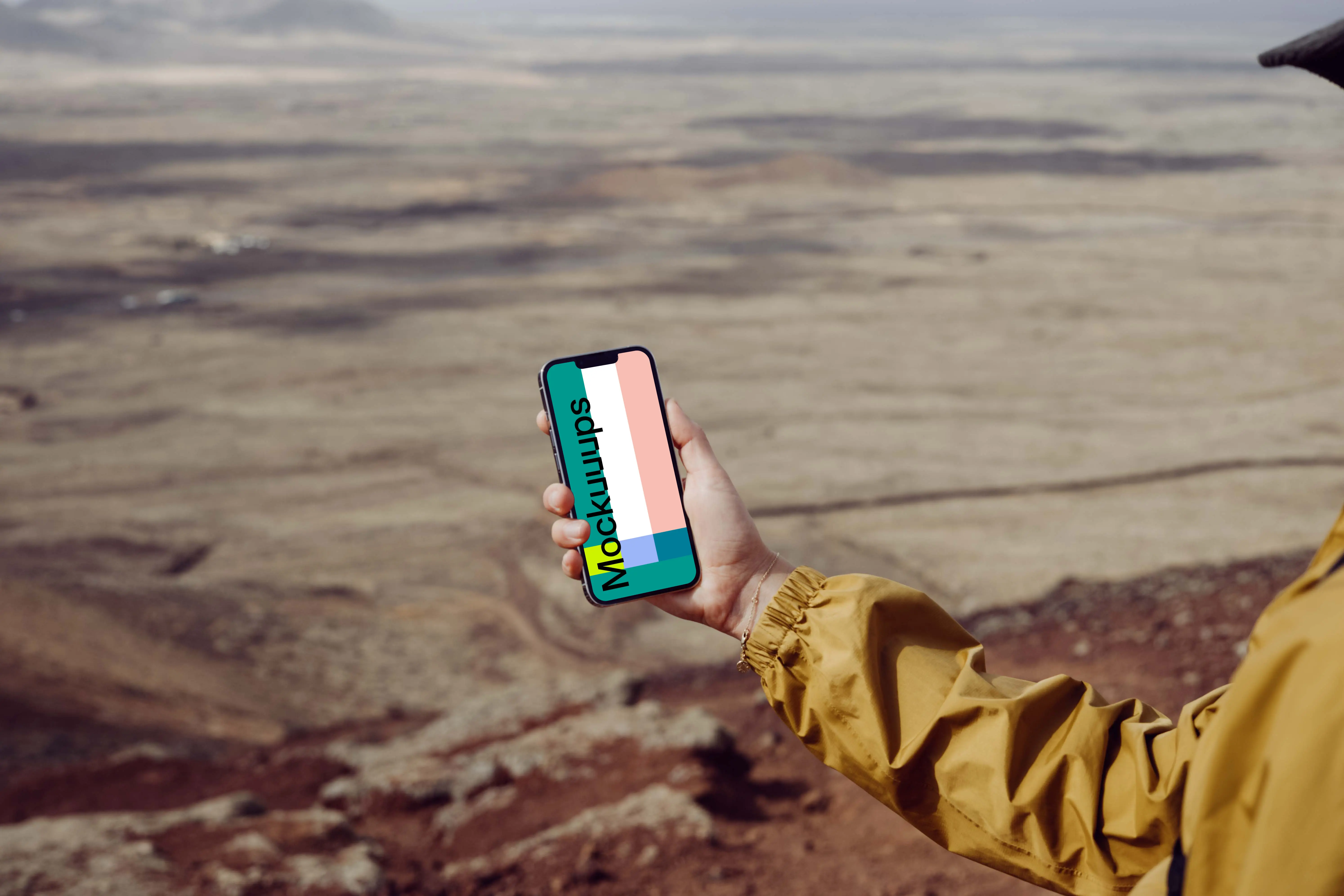 iPhone 13 Pro mockup held by a user over a large field